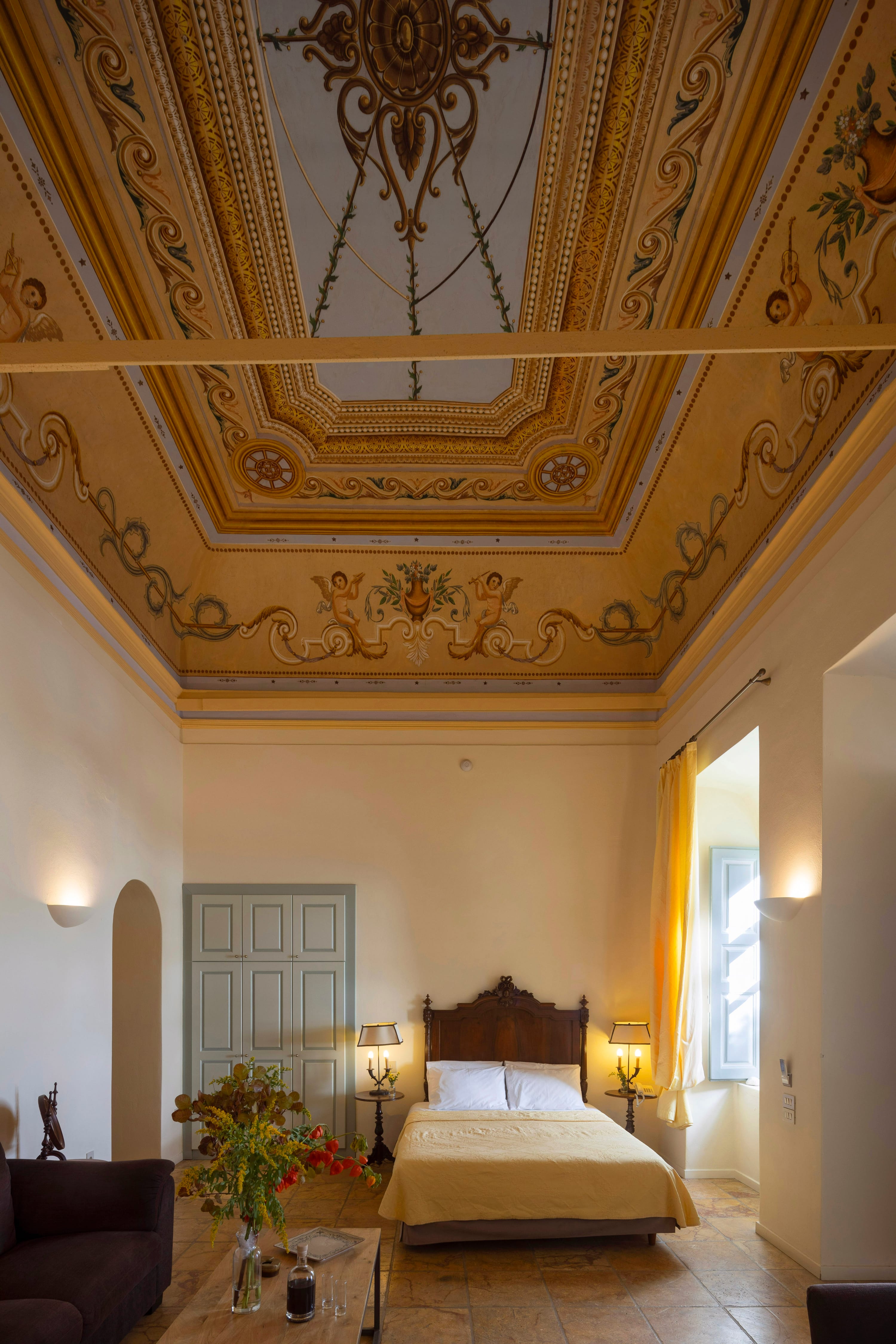 a bedroom with a large chandelier over the bed