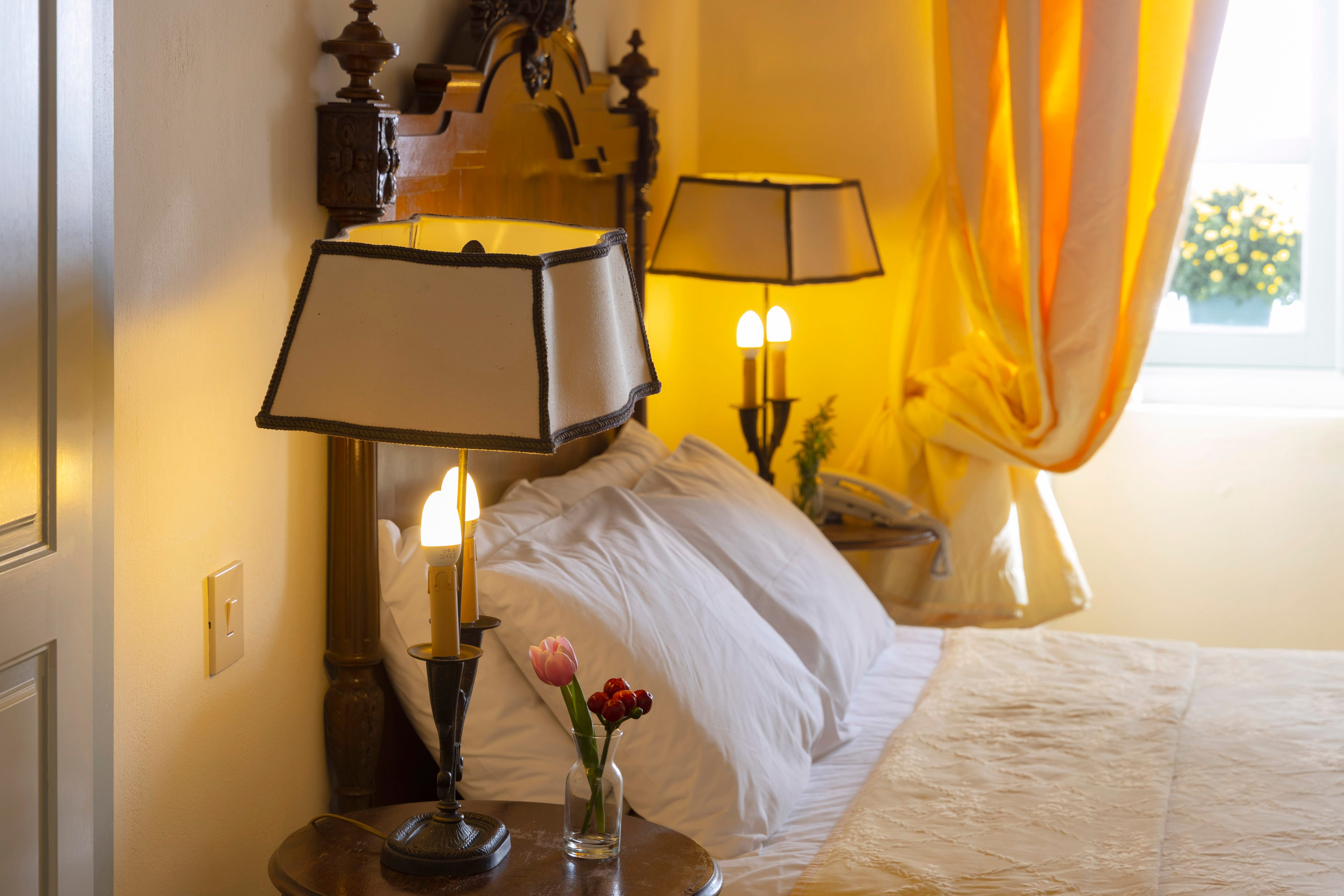 a bed with lamps on either side of it