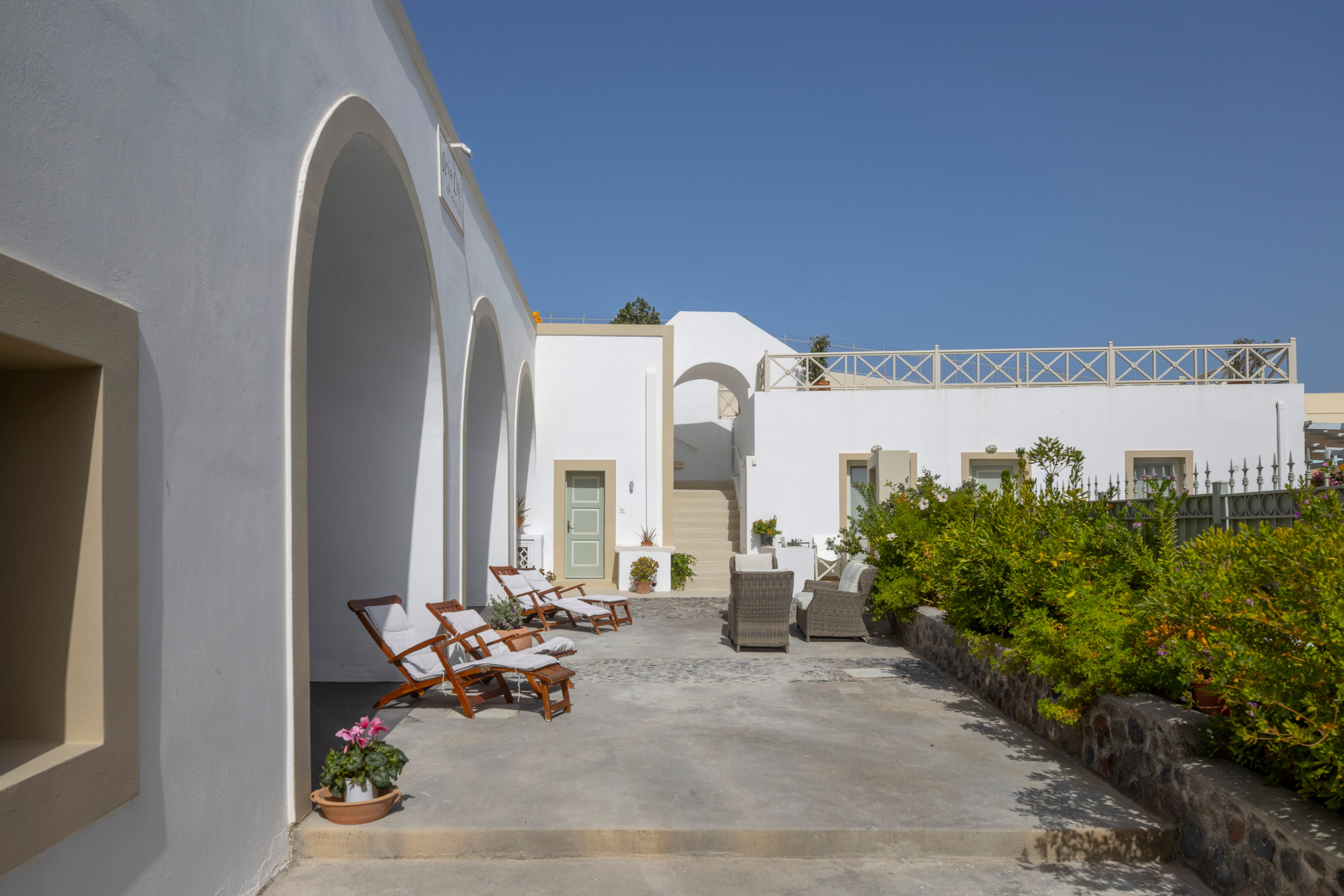 a courtyard with a building and plants