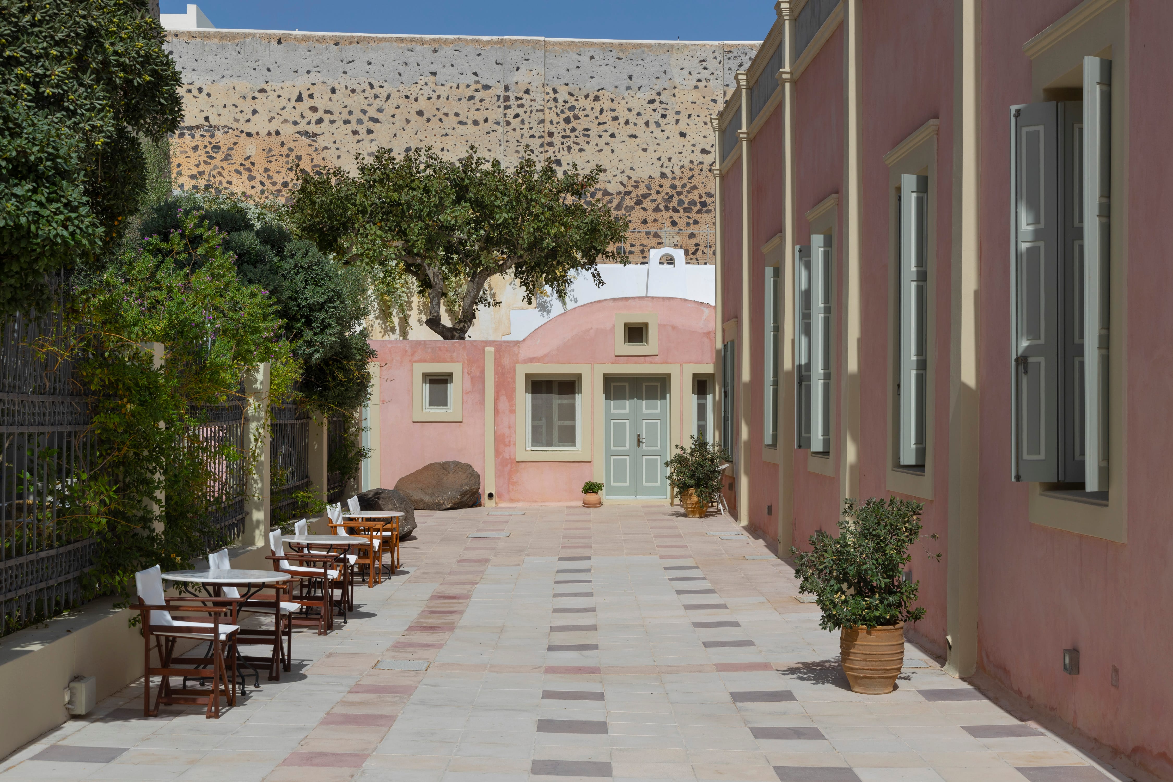 a courtyard with tables and chairs