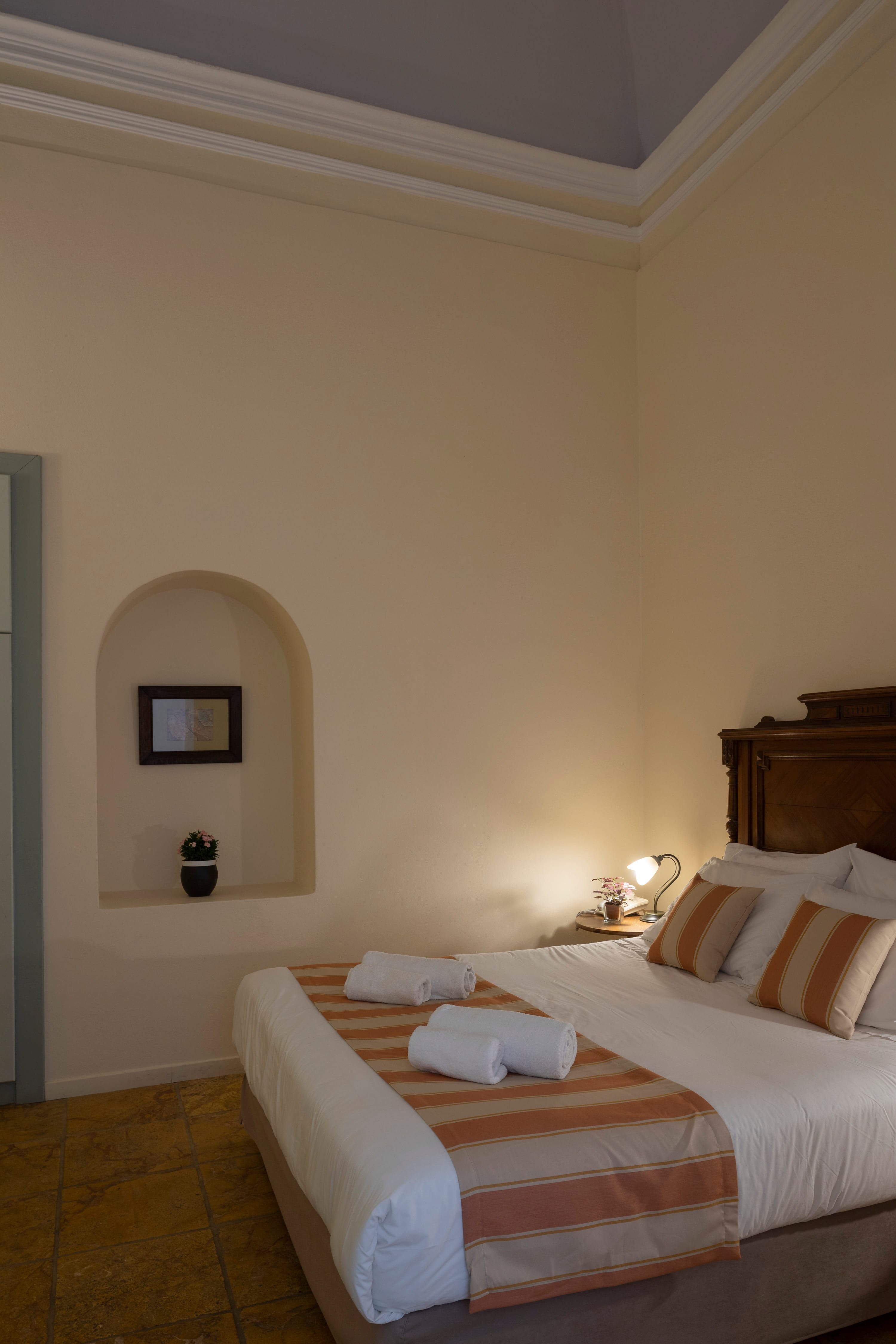 a bed with a mirror above it