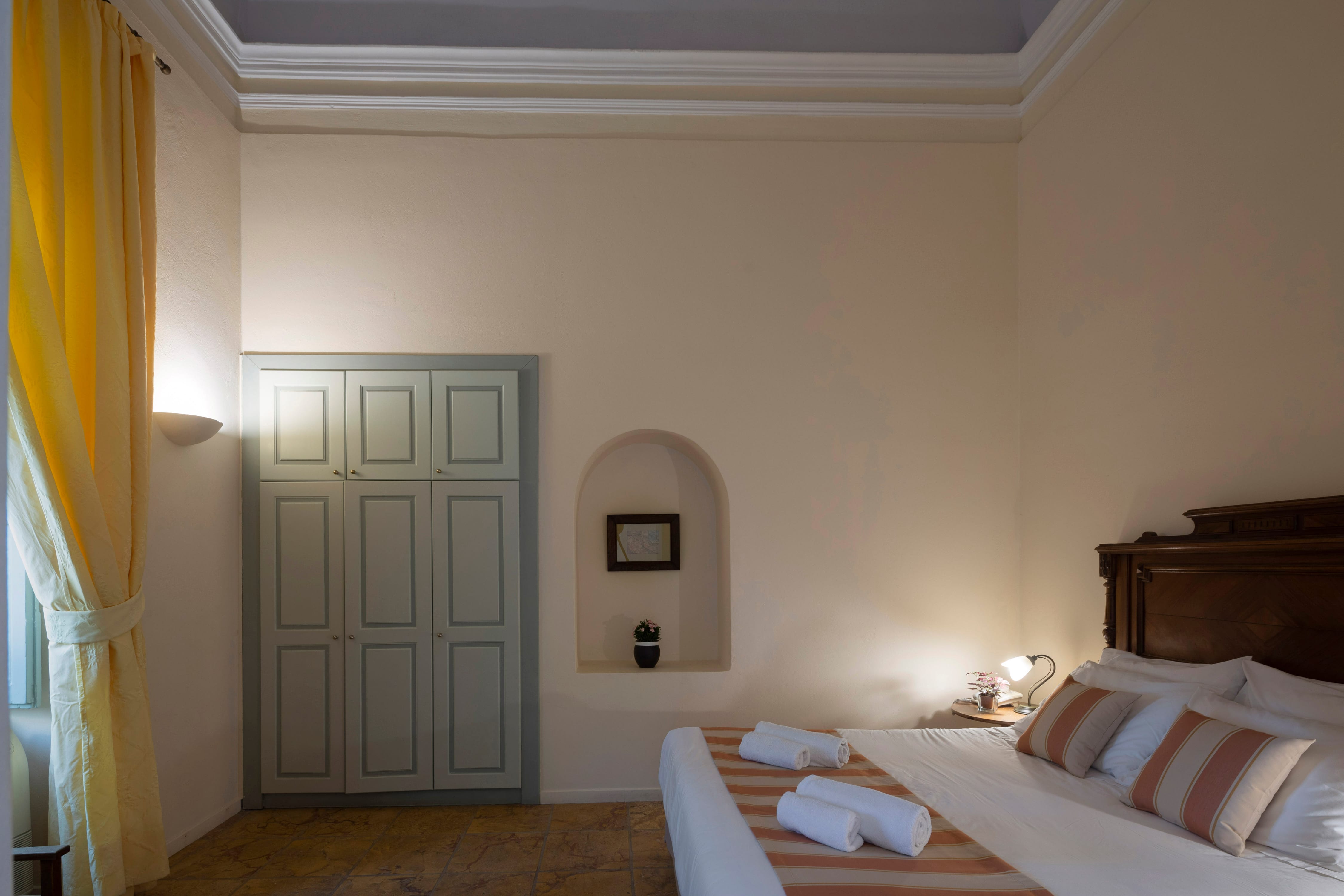 a bedroom with a mirror and a bed