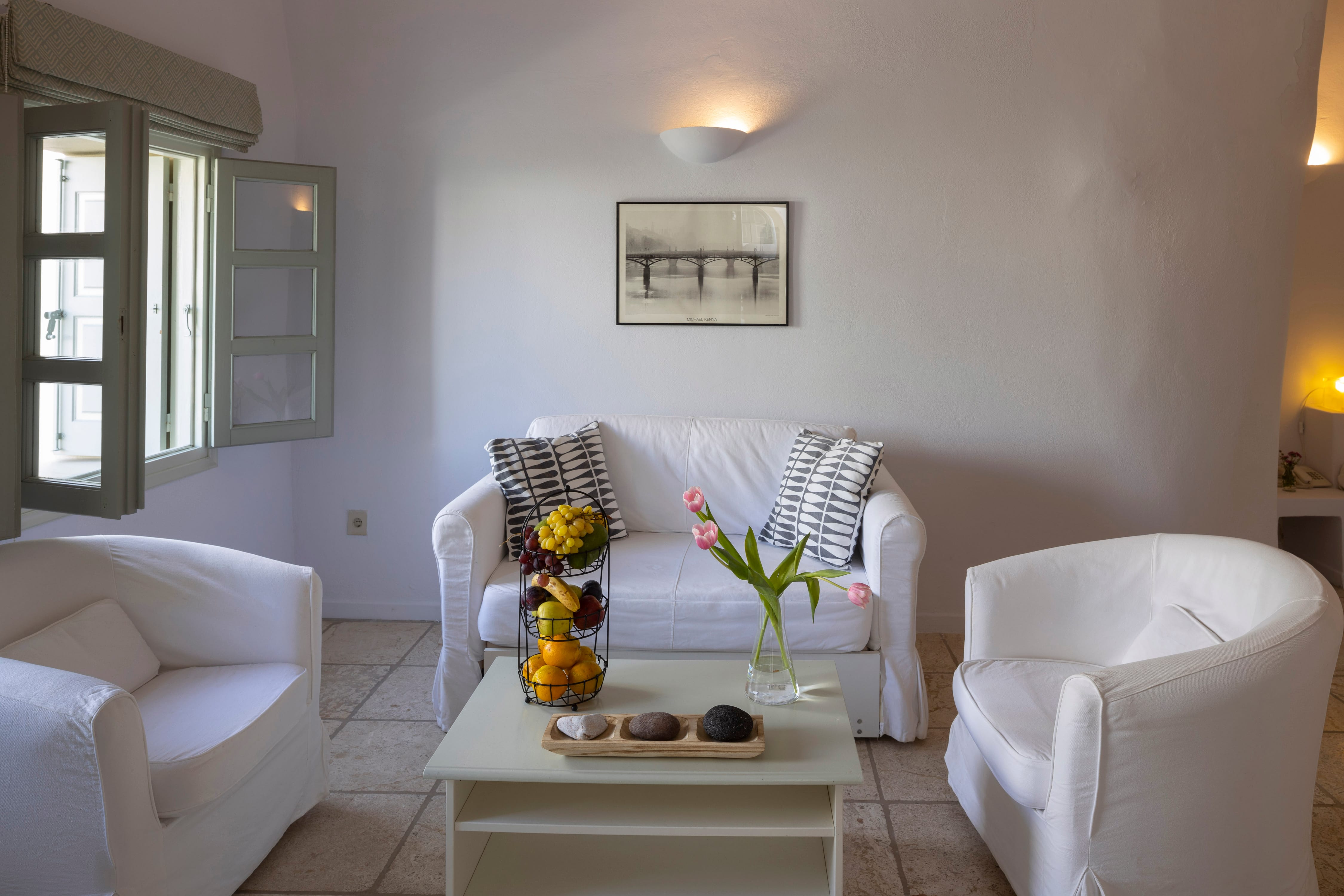 a living room with white furniture