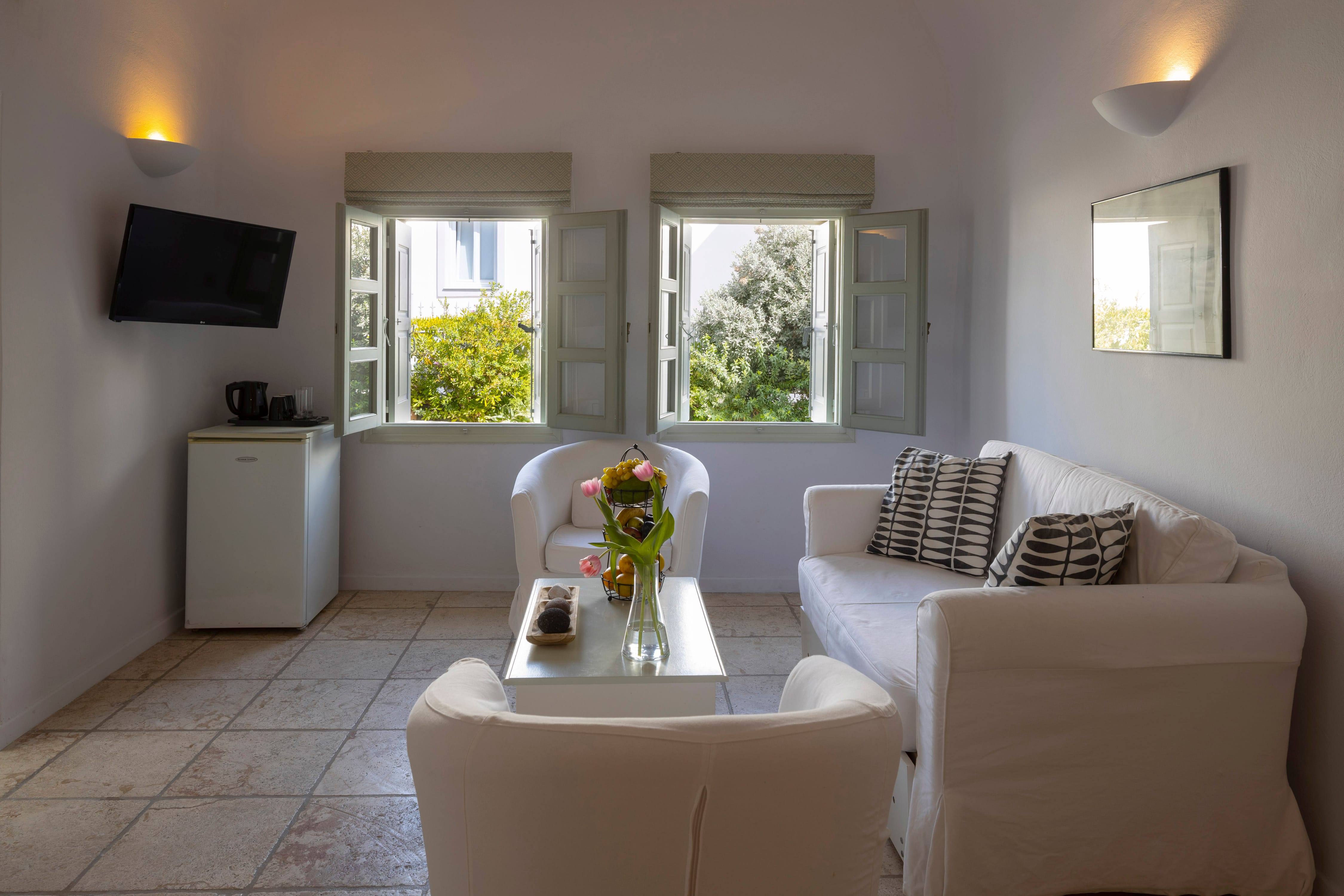 a living room with white furniture