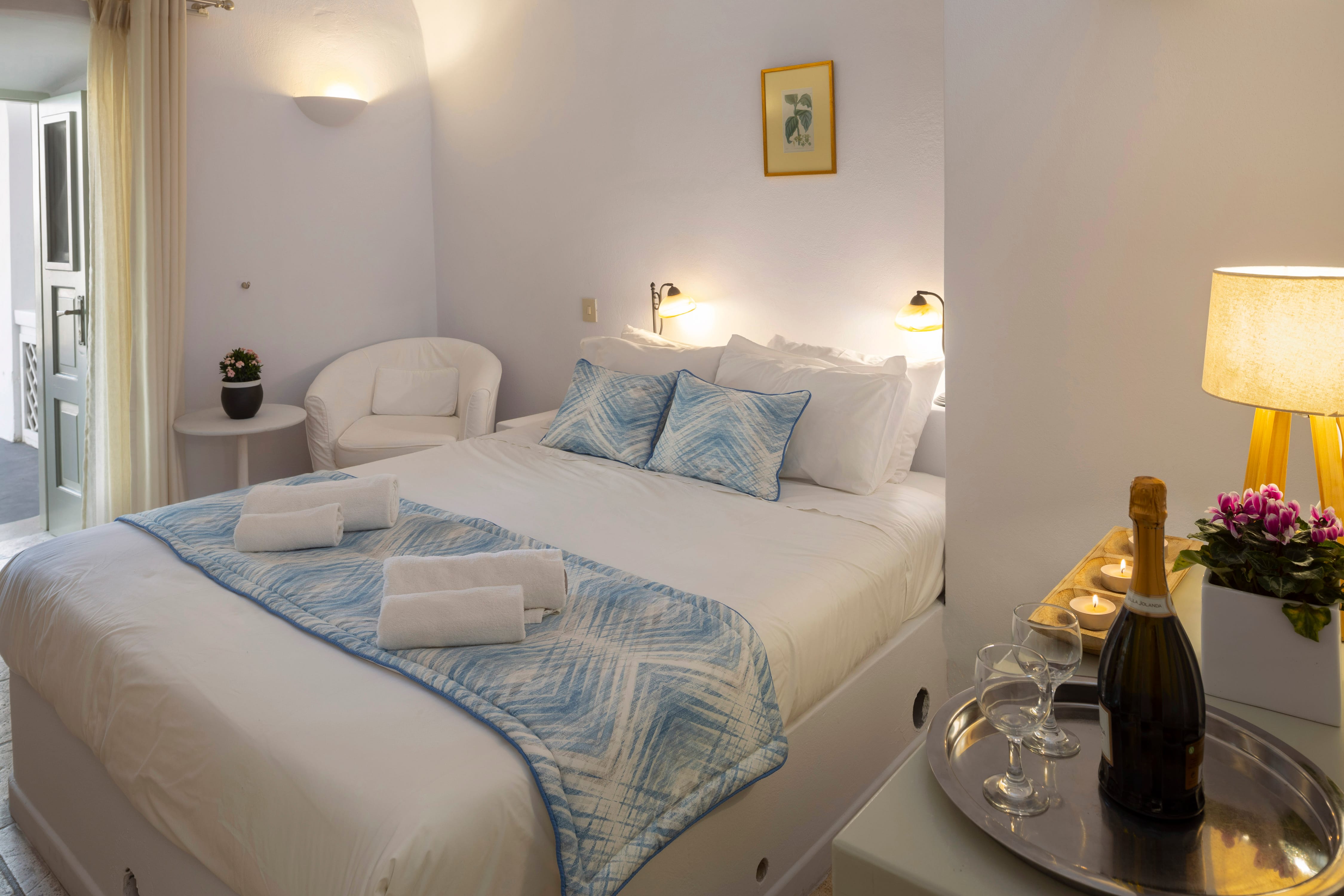 a hotel room with a bed and a wine bottle