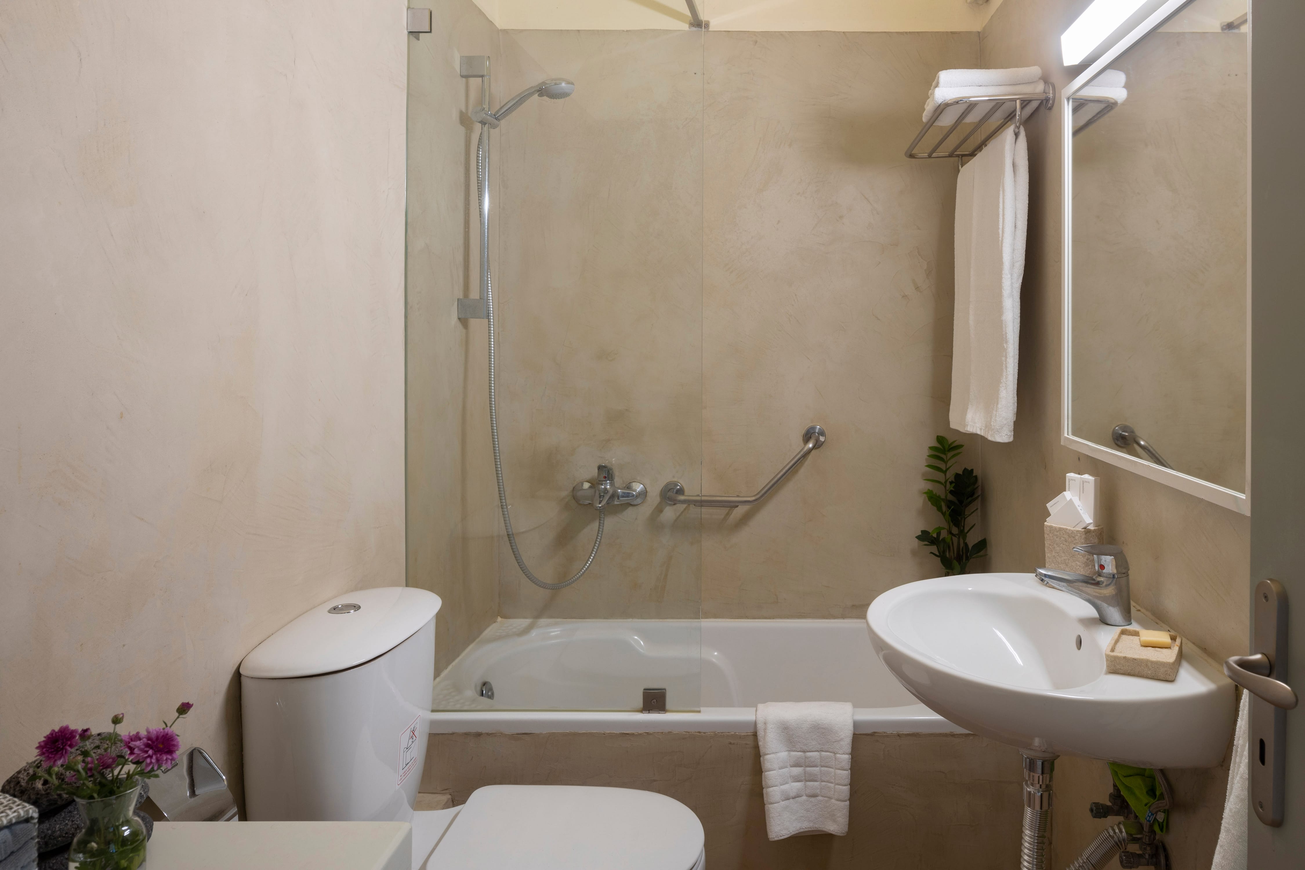 a bathroom with a tub sink and toilet
