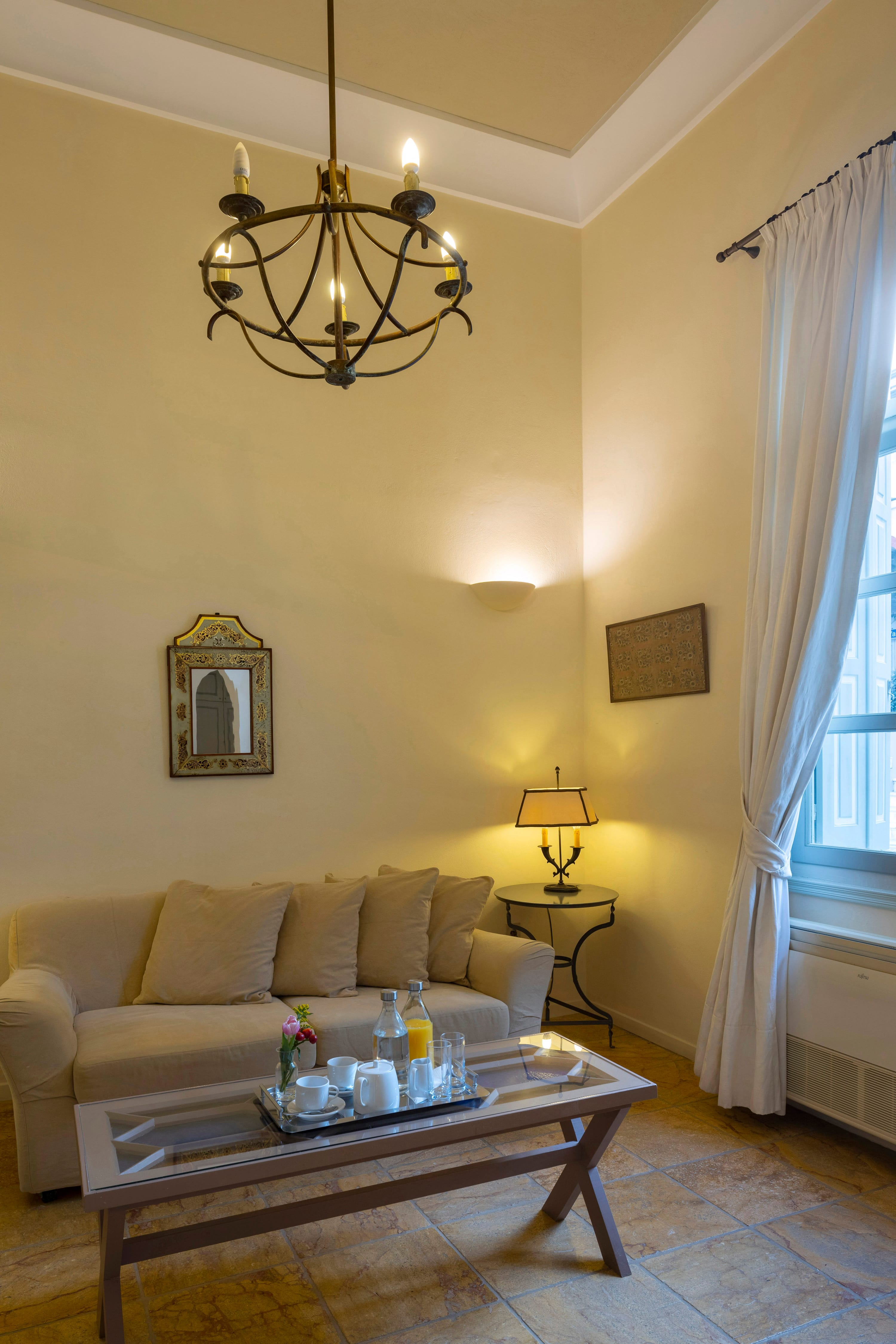 a living room with a chandelier and a couch
