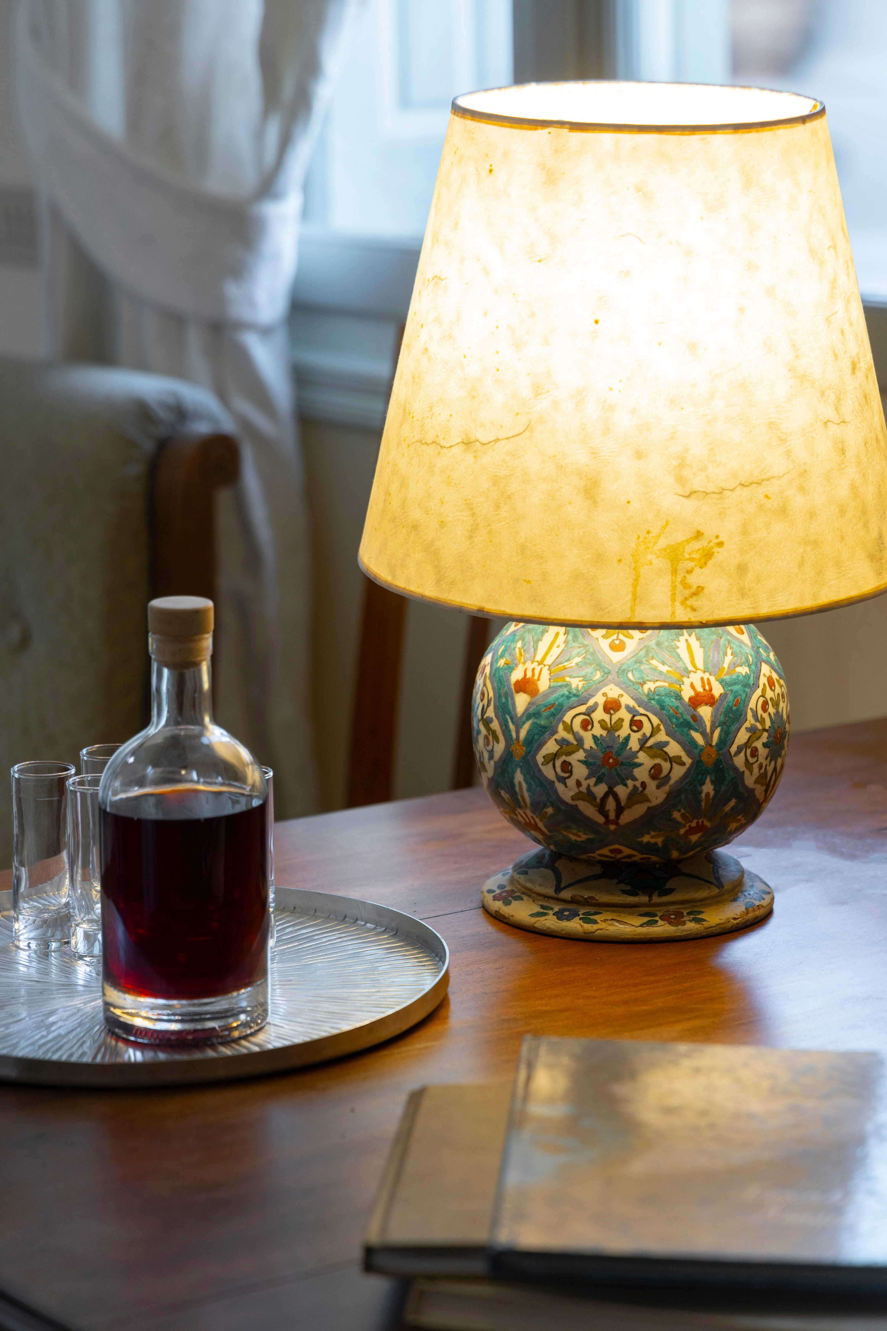 a lamp and a glass bottle on a table