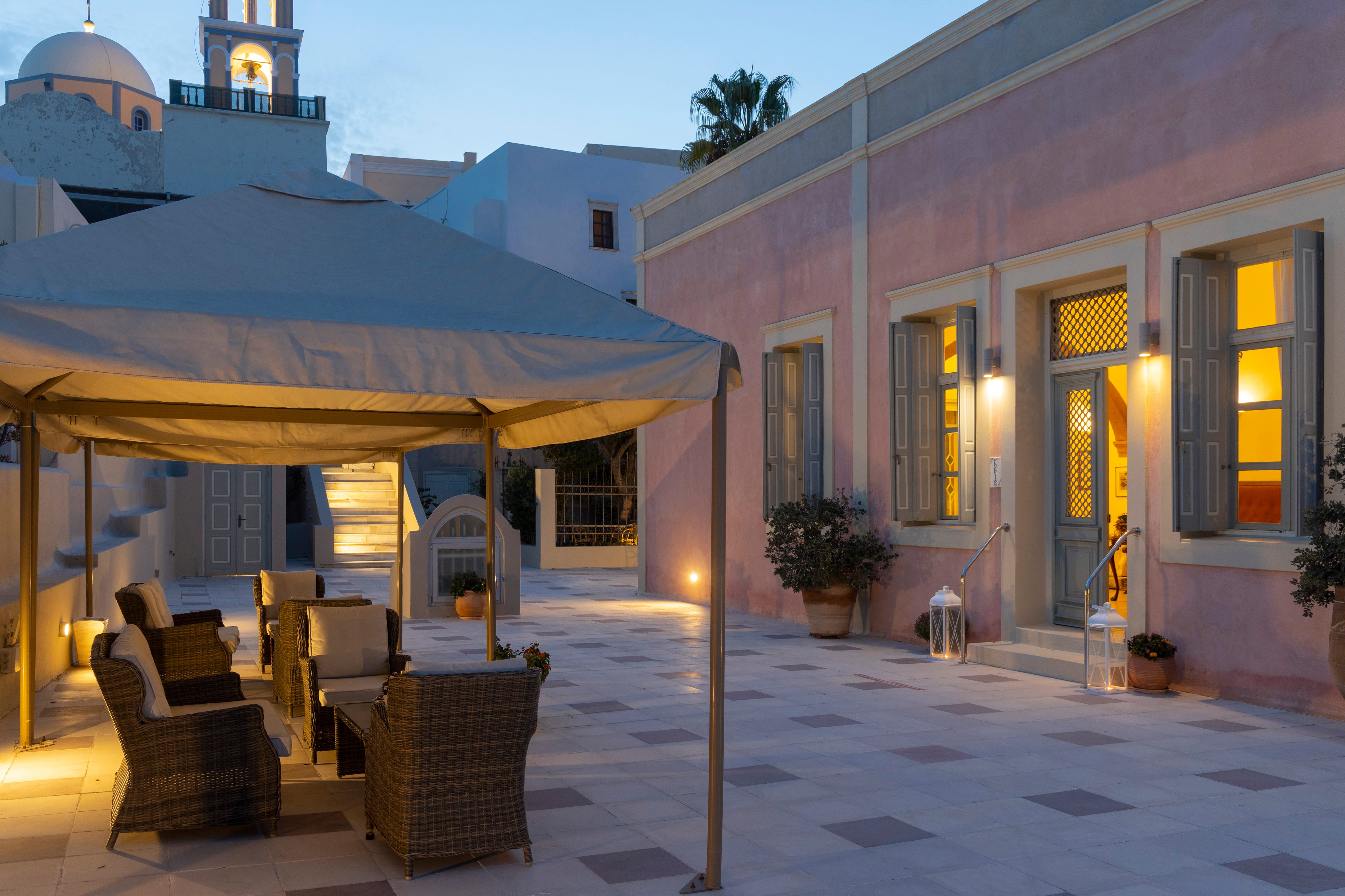a patio with chairs and umbrellas