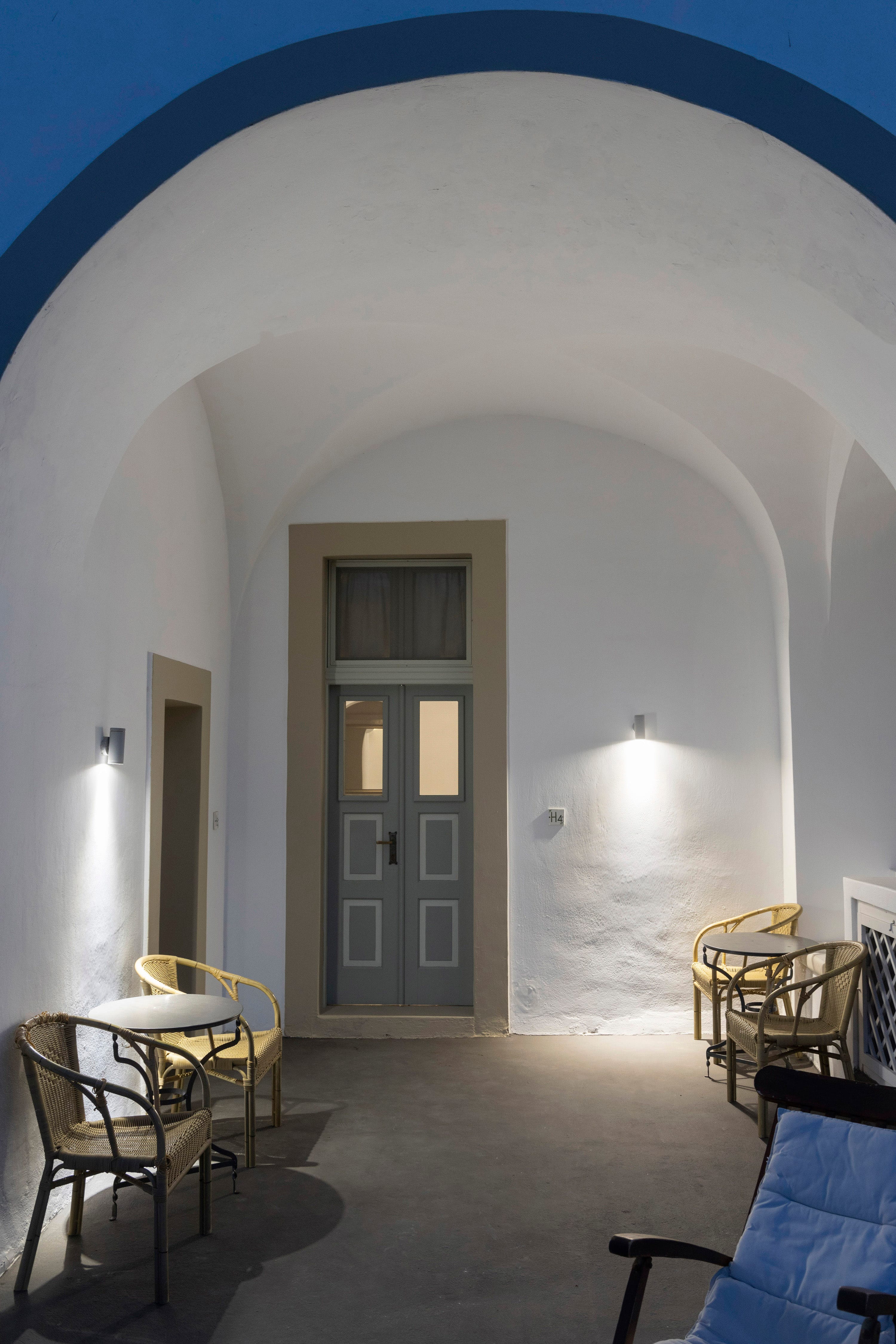 a room with a door and chairs