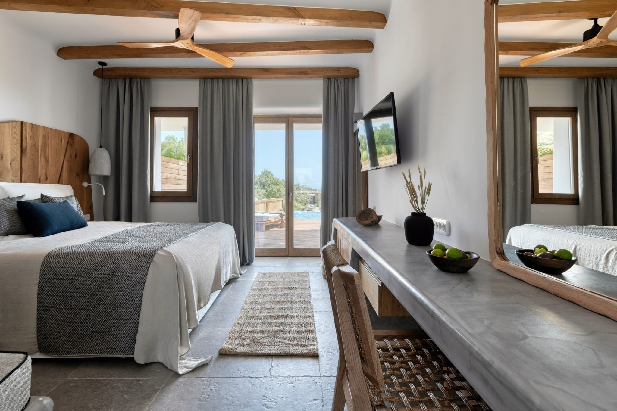 a bedroom with a large bed and a tv