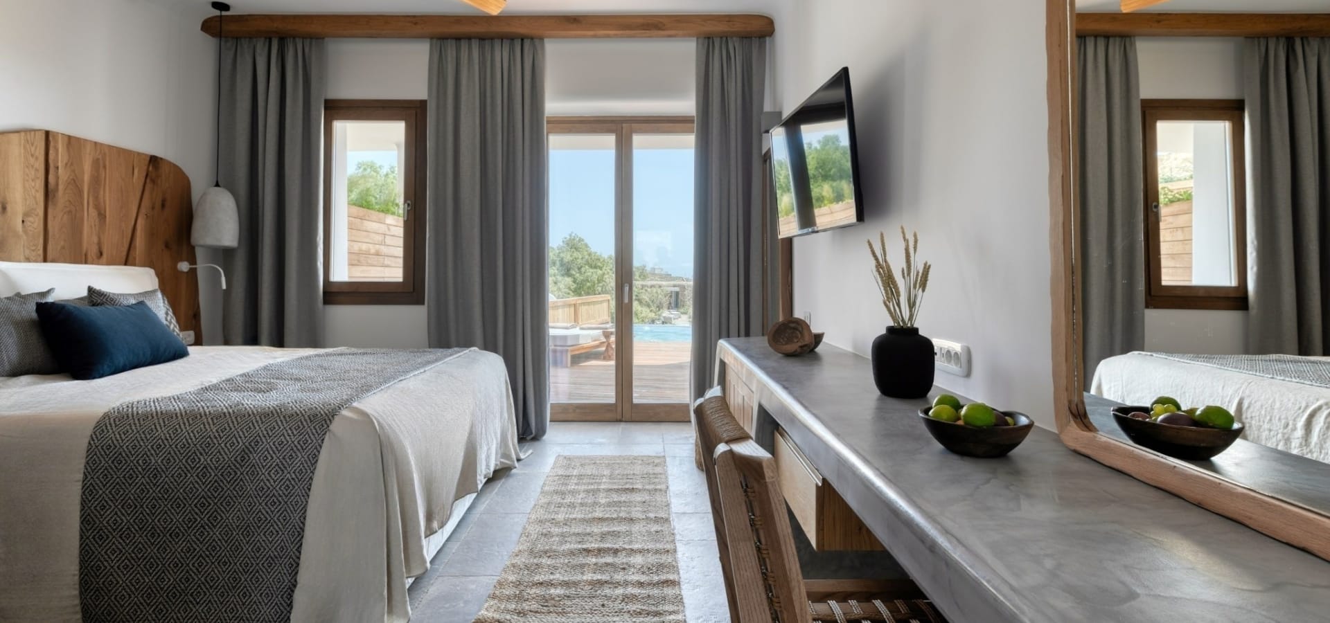 a bedroom with a large bed and a tv