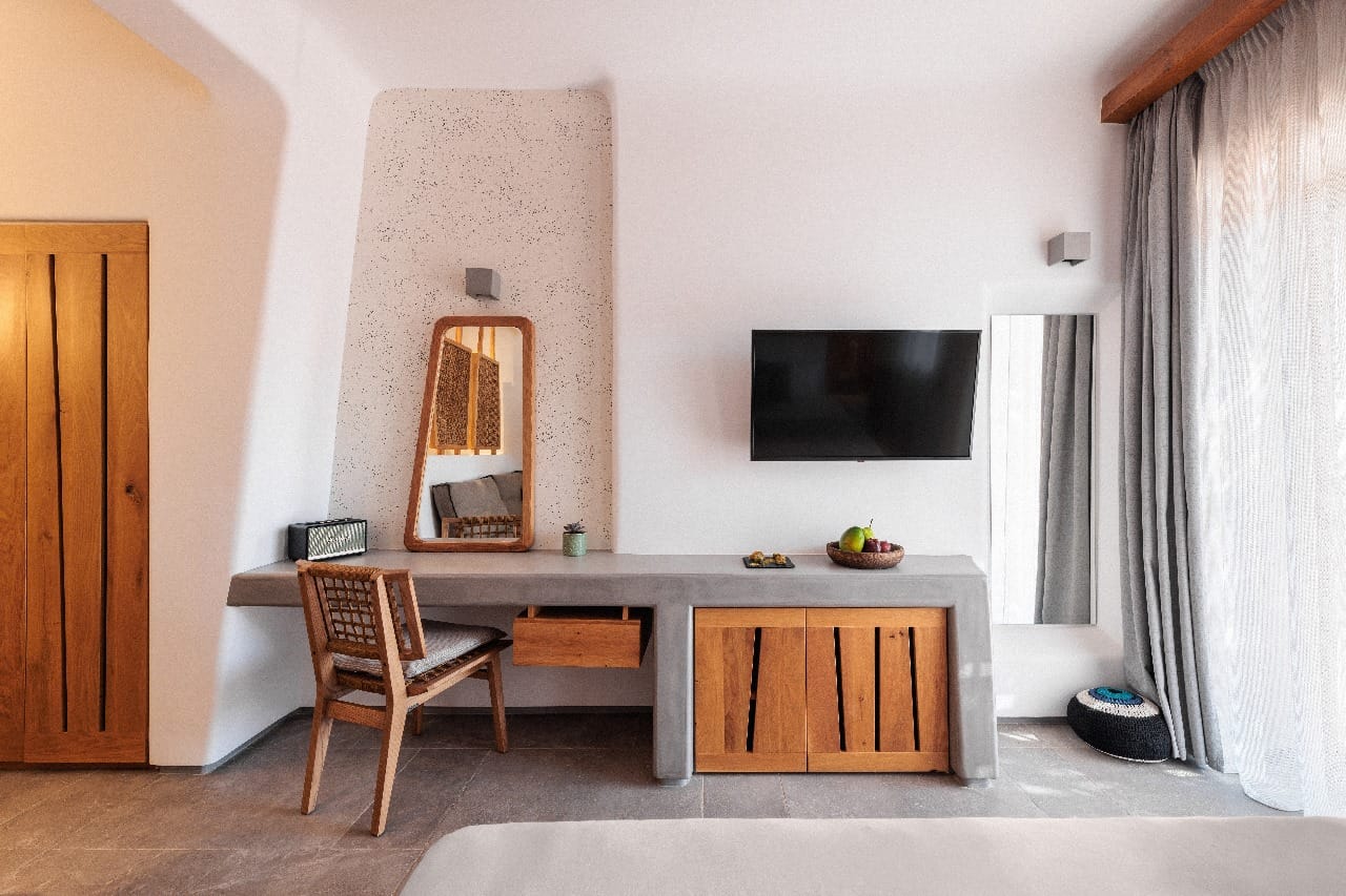 a room with a desk and a tv