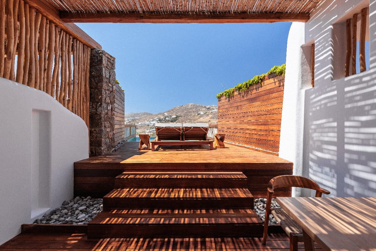 a wood deck with a chair and a table on it