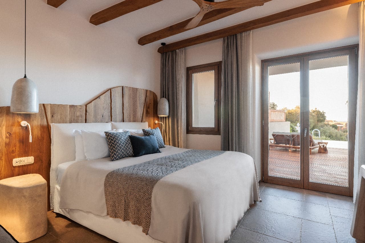 a bedroom with a large glass door