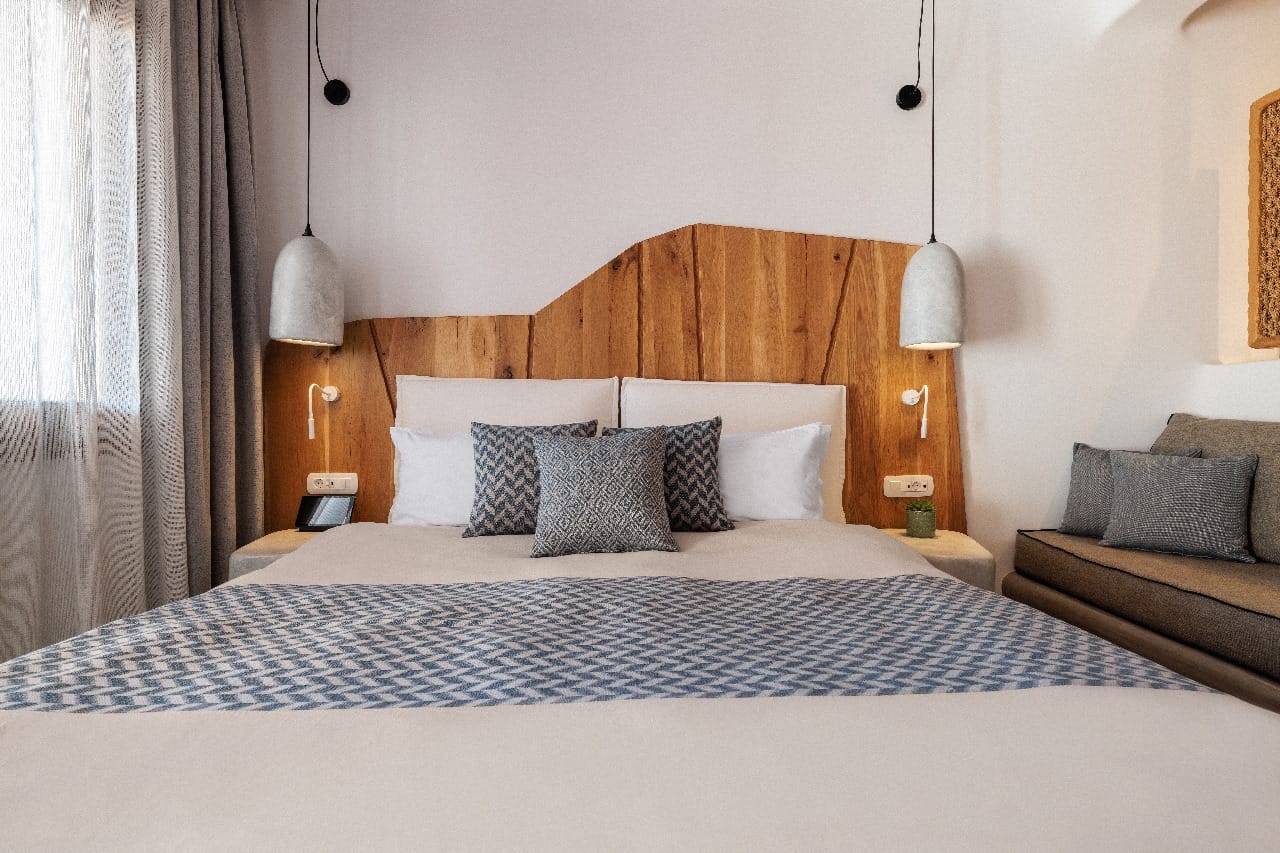 a bed with a blue and white striped bed spread