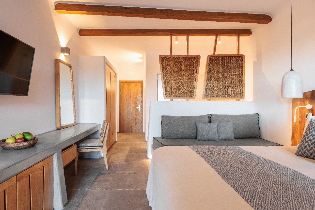 a bedroom with a bed and a tv