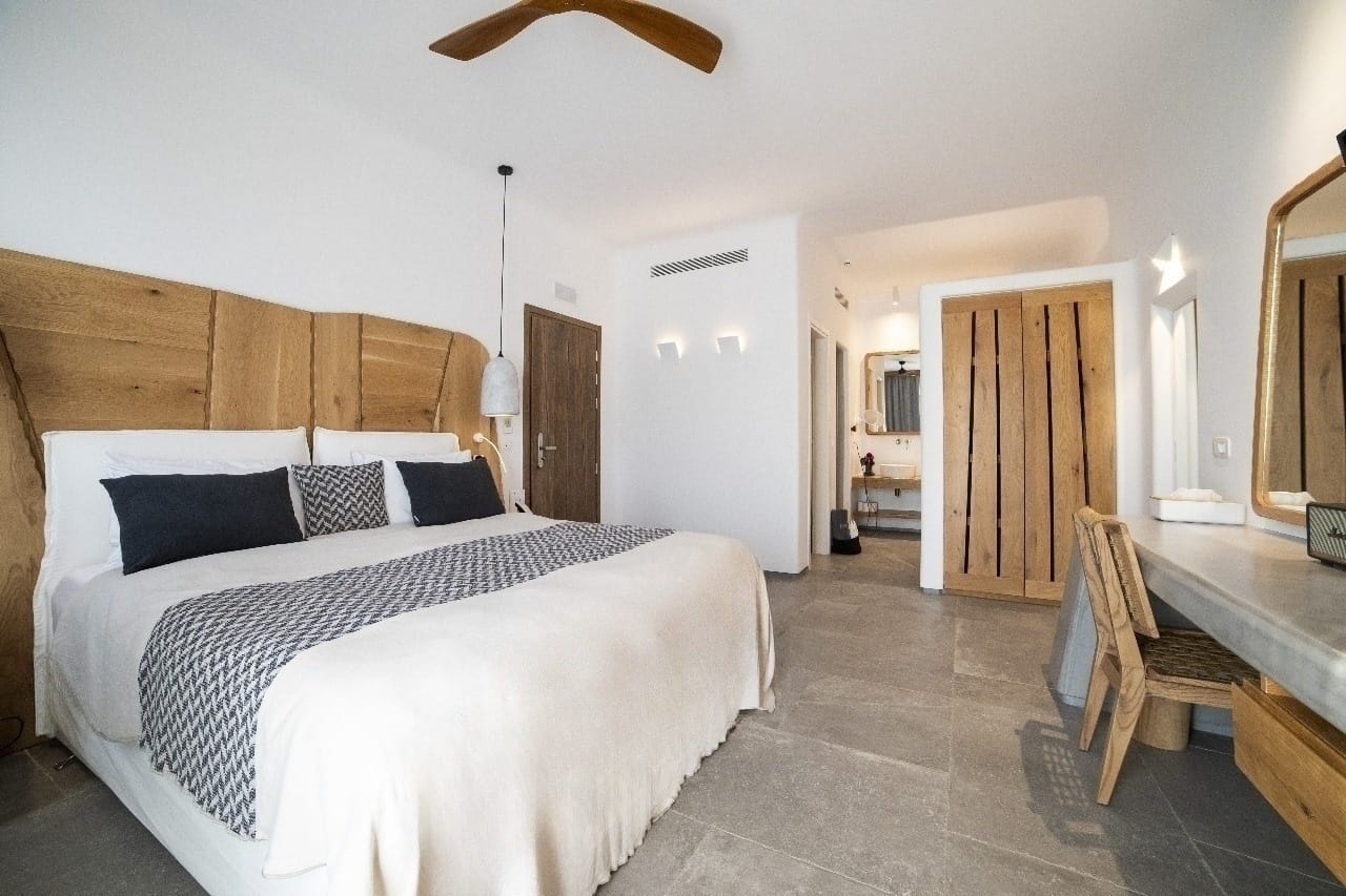 a bedroom with a bed and a chair