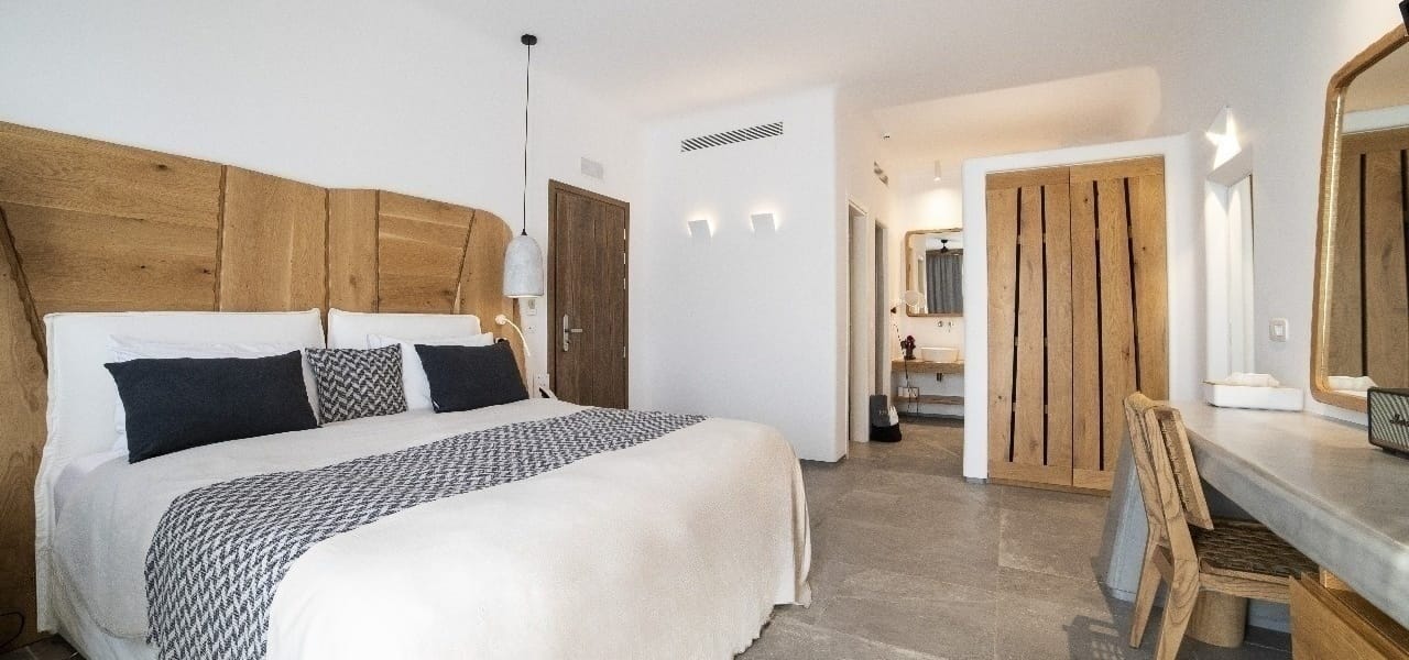 a bedroom with a bed and a chair