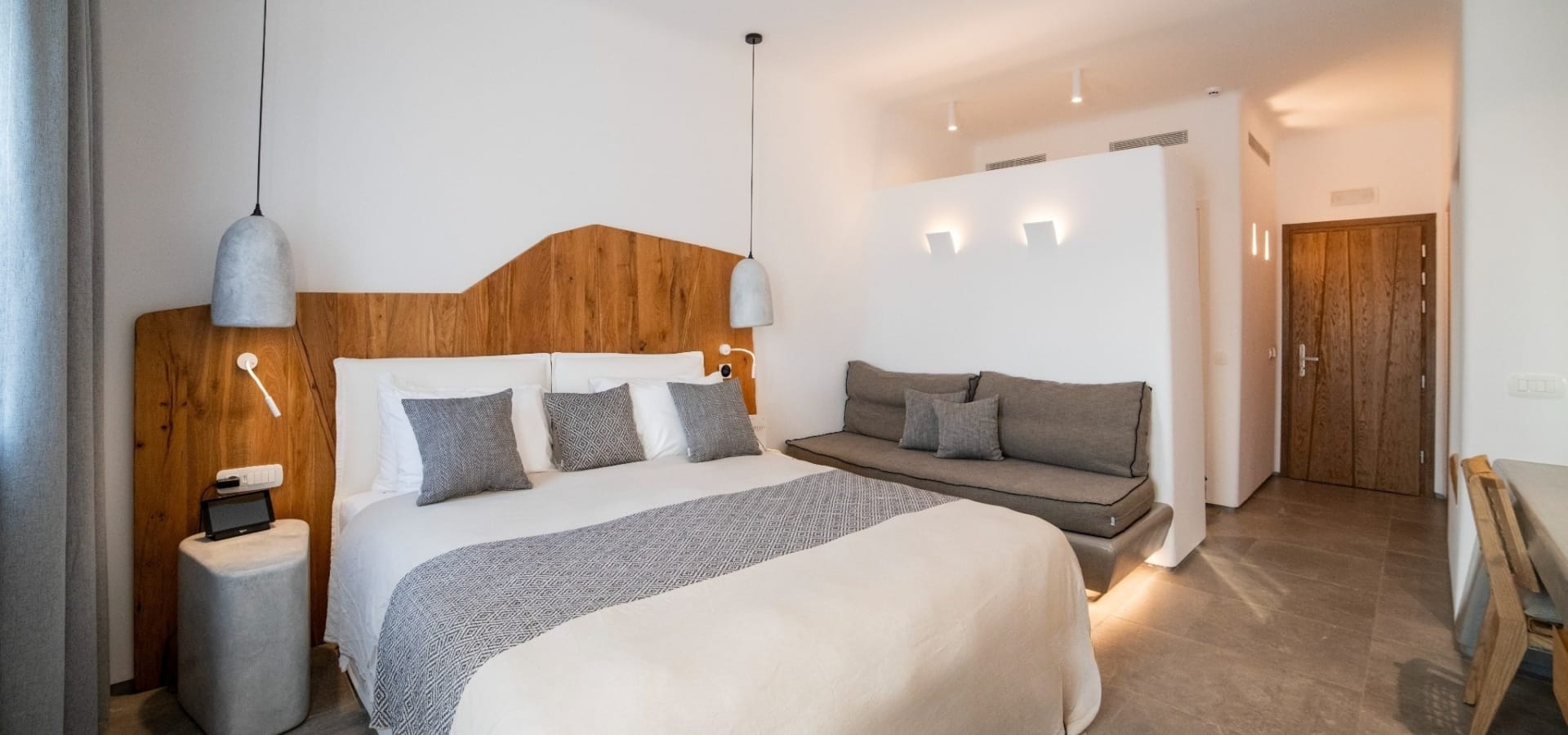 a bedroom with a bed and couch