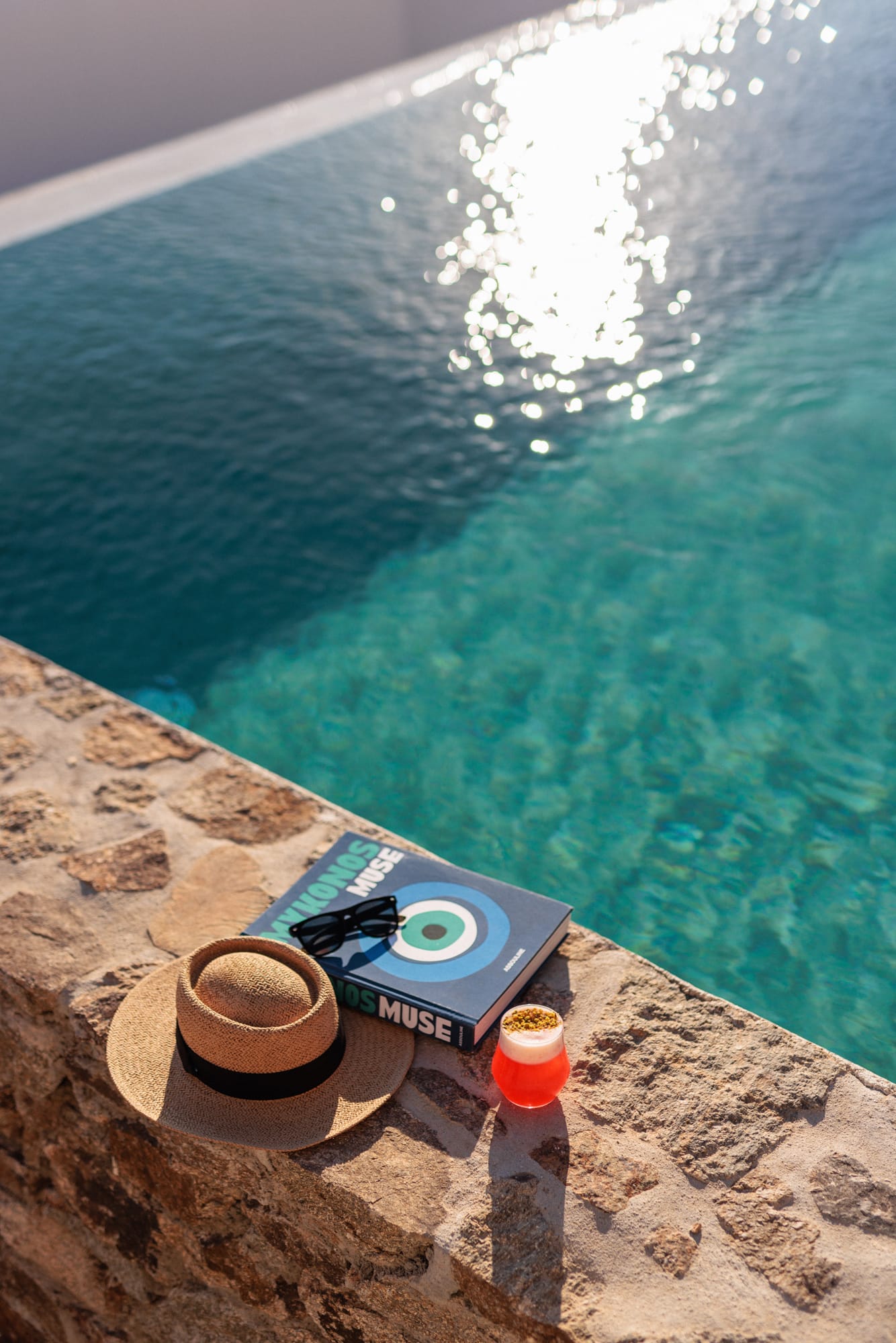 a pair of flip flops on a rock by a body of water