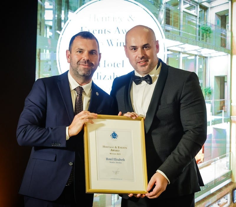 a couple of men holding a plaque