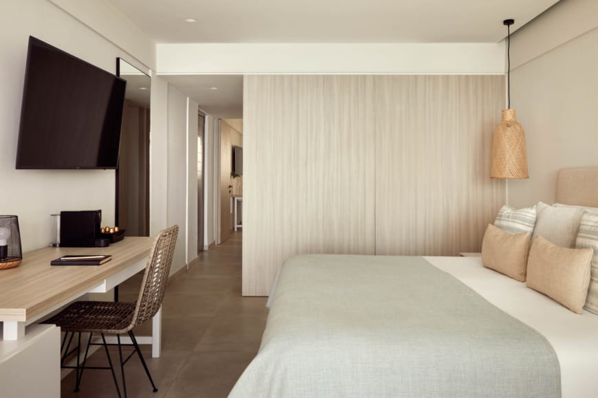 a bedroom with a bed and a desk