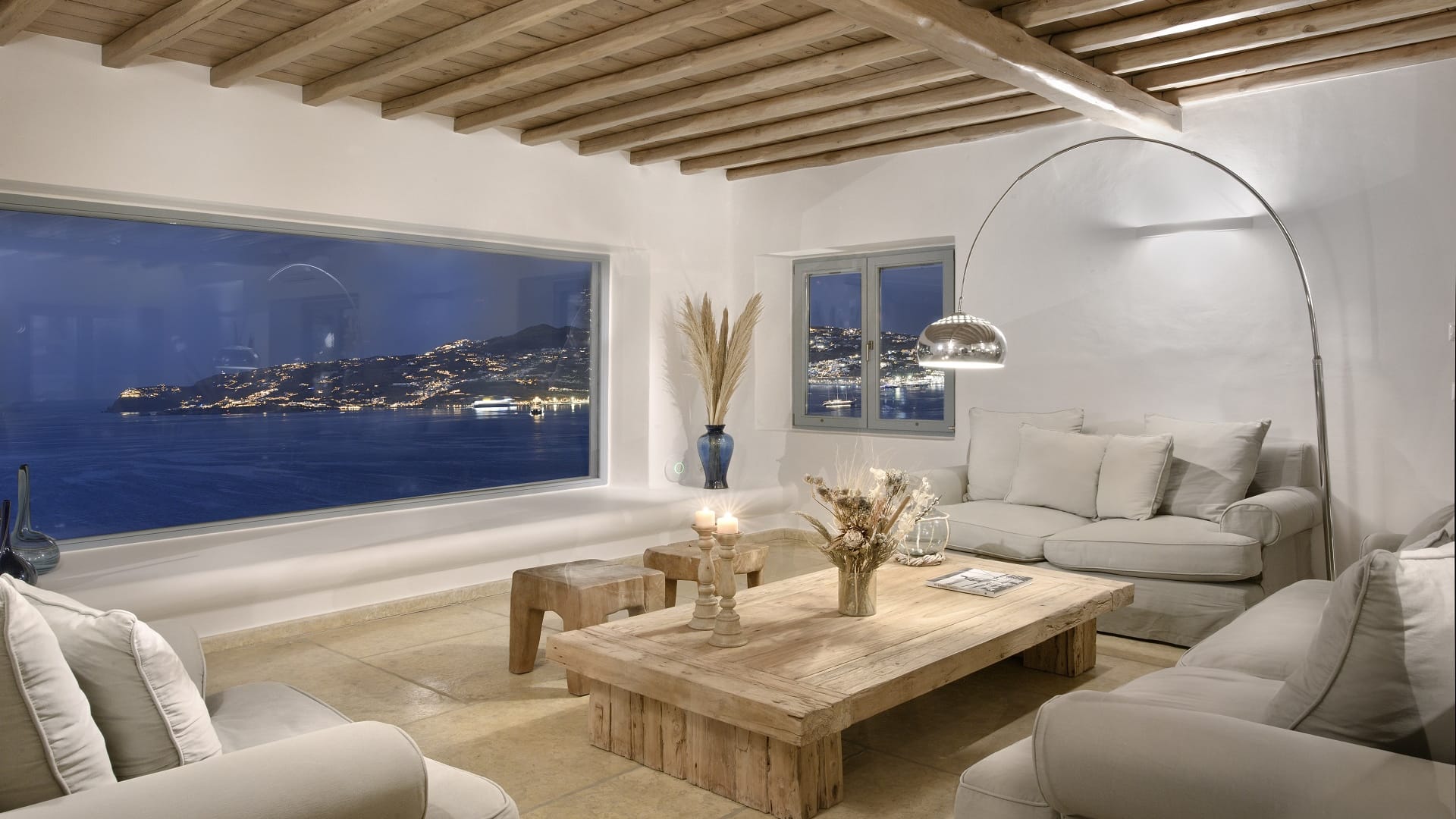 Living room with panoramic view of Mykonos Town and sunsets.