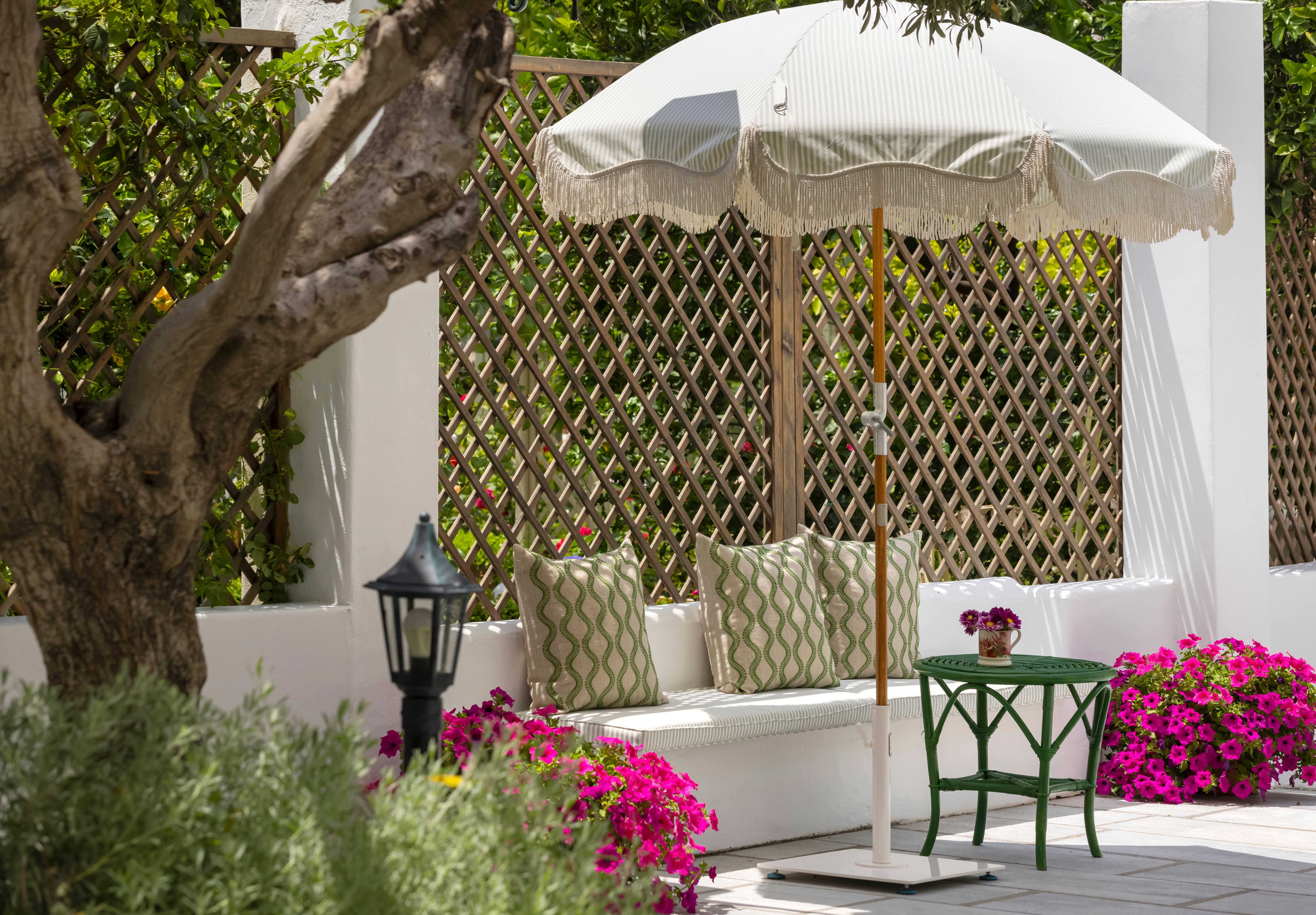 a white couch with a table and umbrella