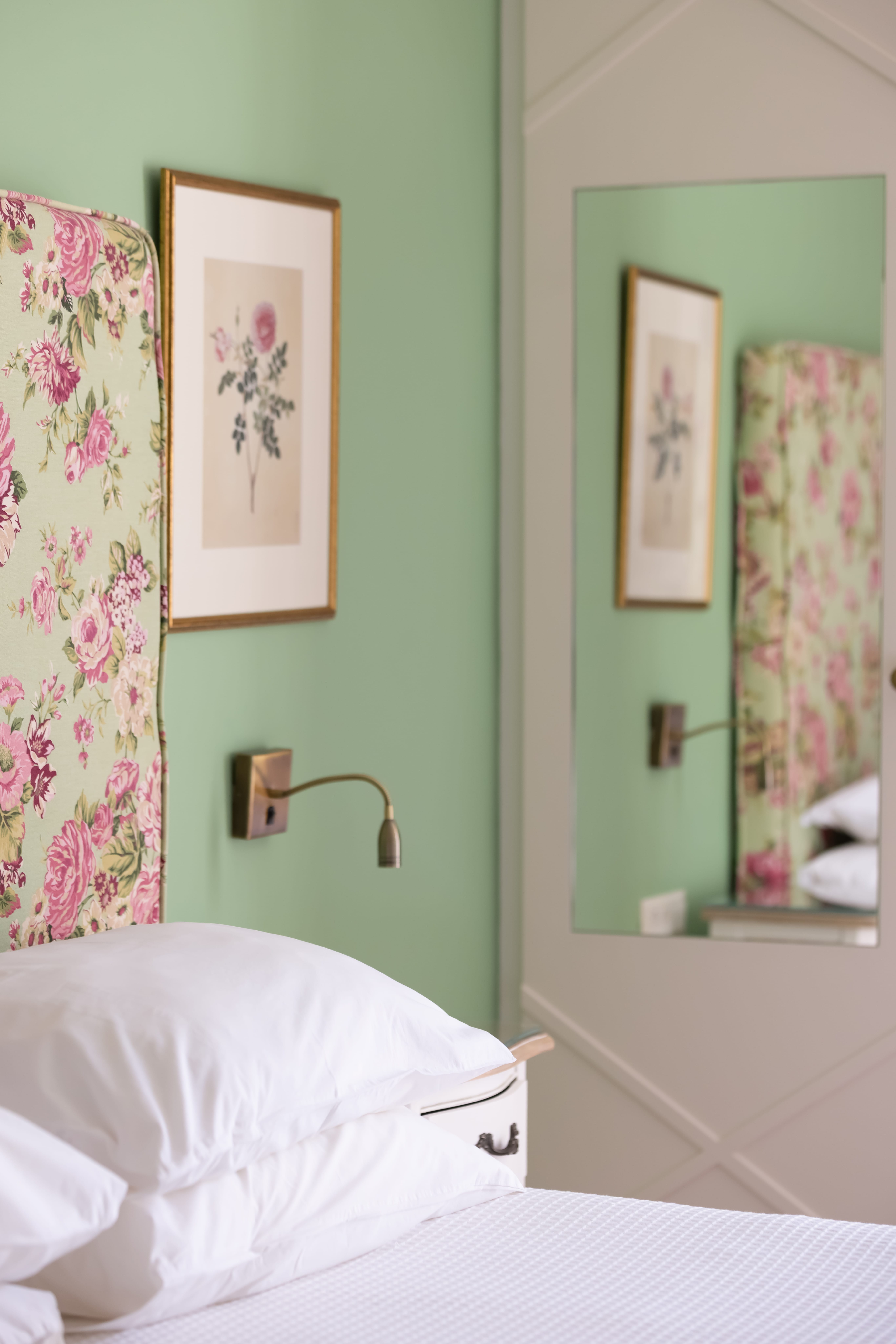 a bed with a floral headboard
