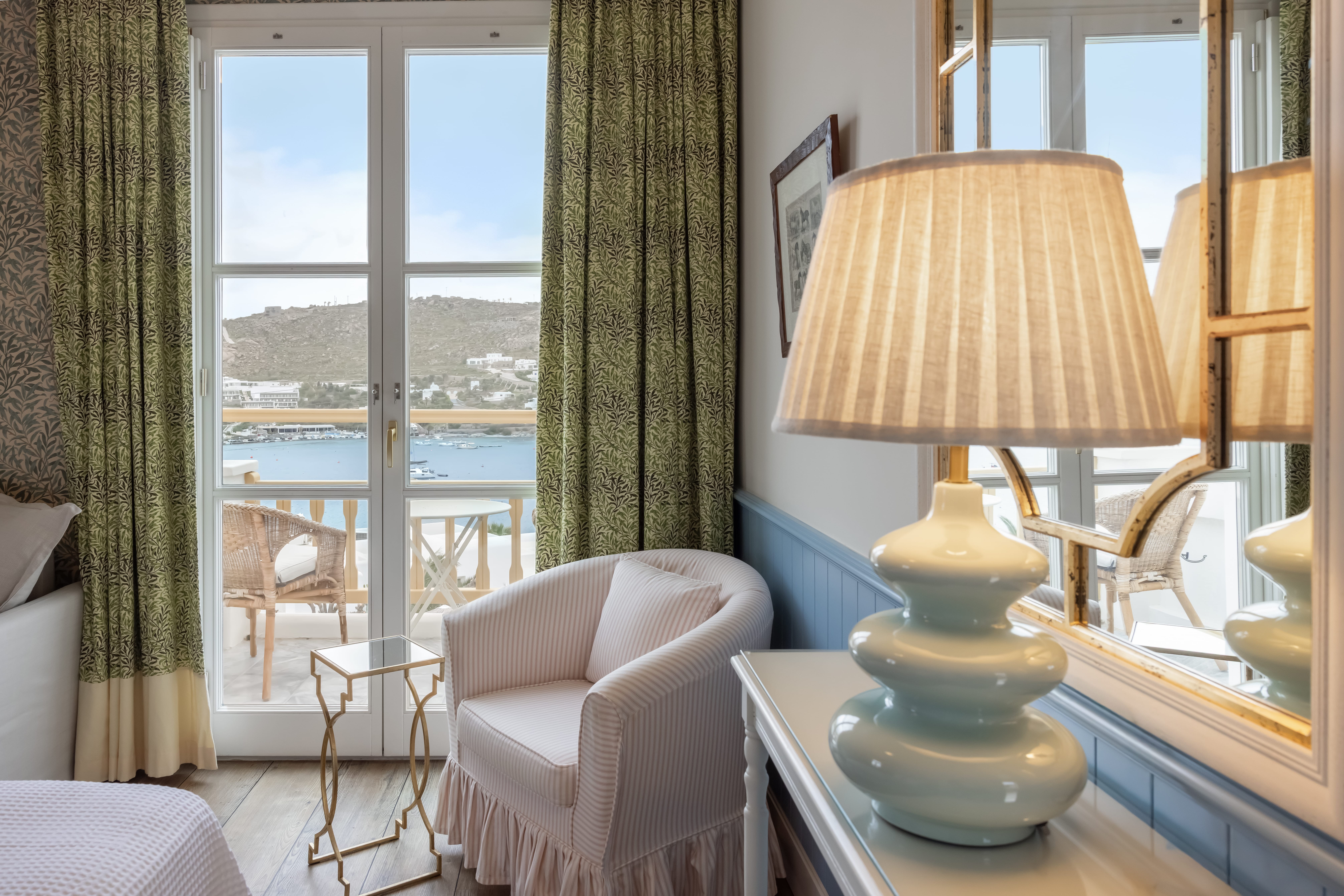 a room with a table lamp and chairs