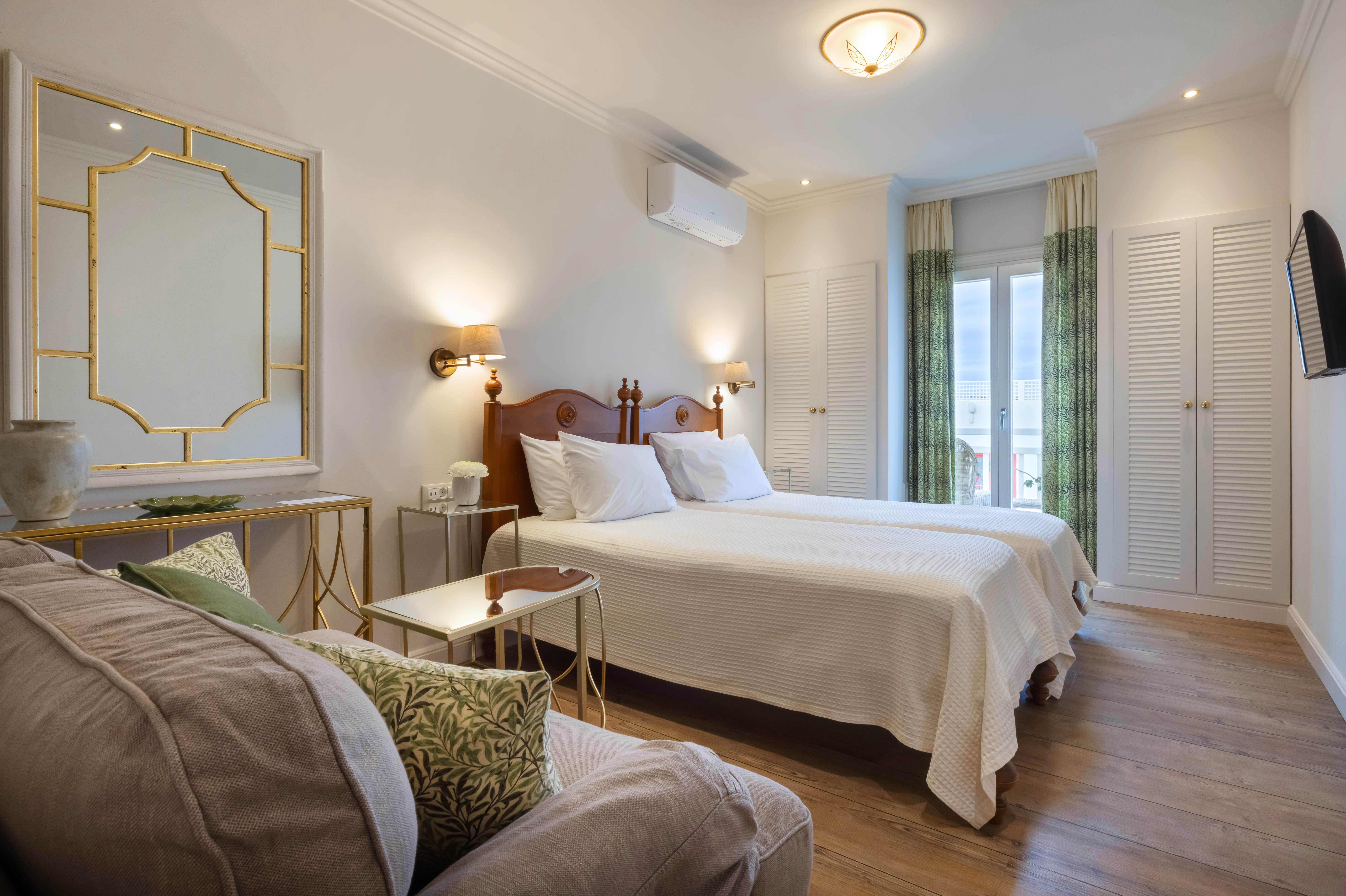 a bedroom with a bed and a couch