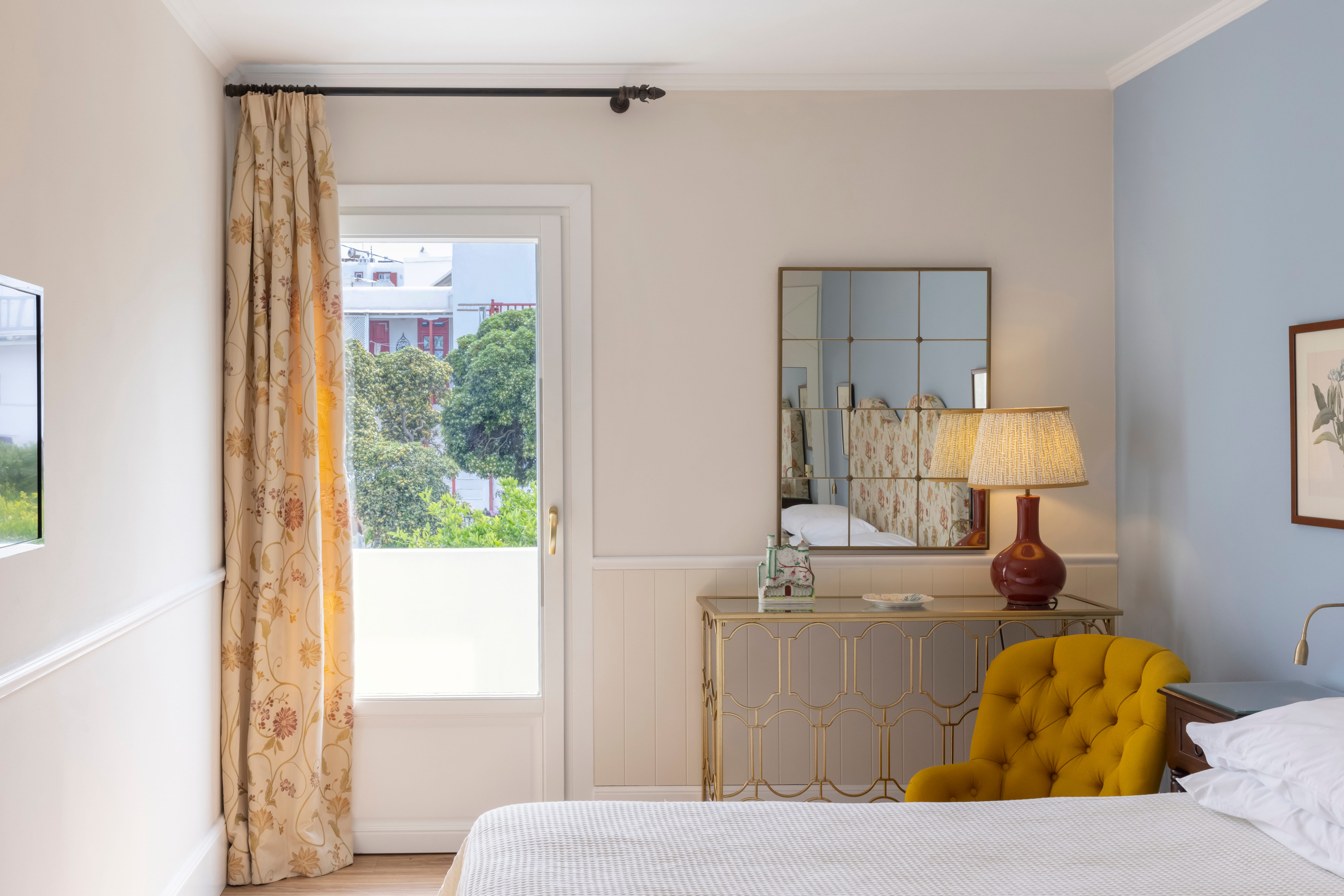 a room with a bed and a mirror