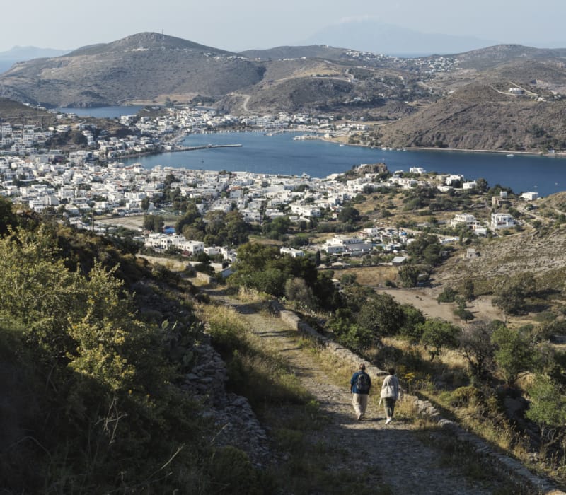 people walking on a path near a body of water