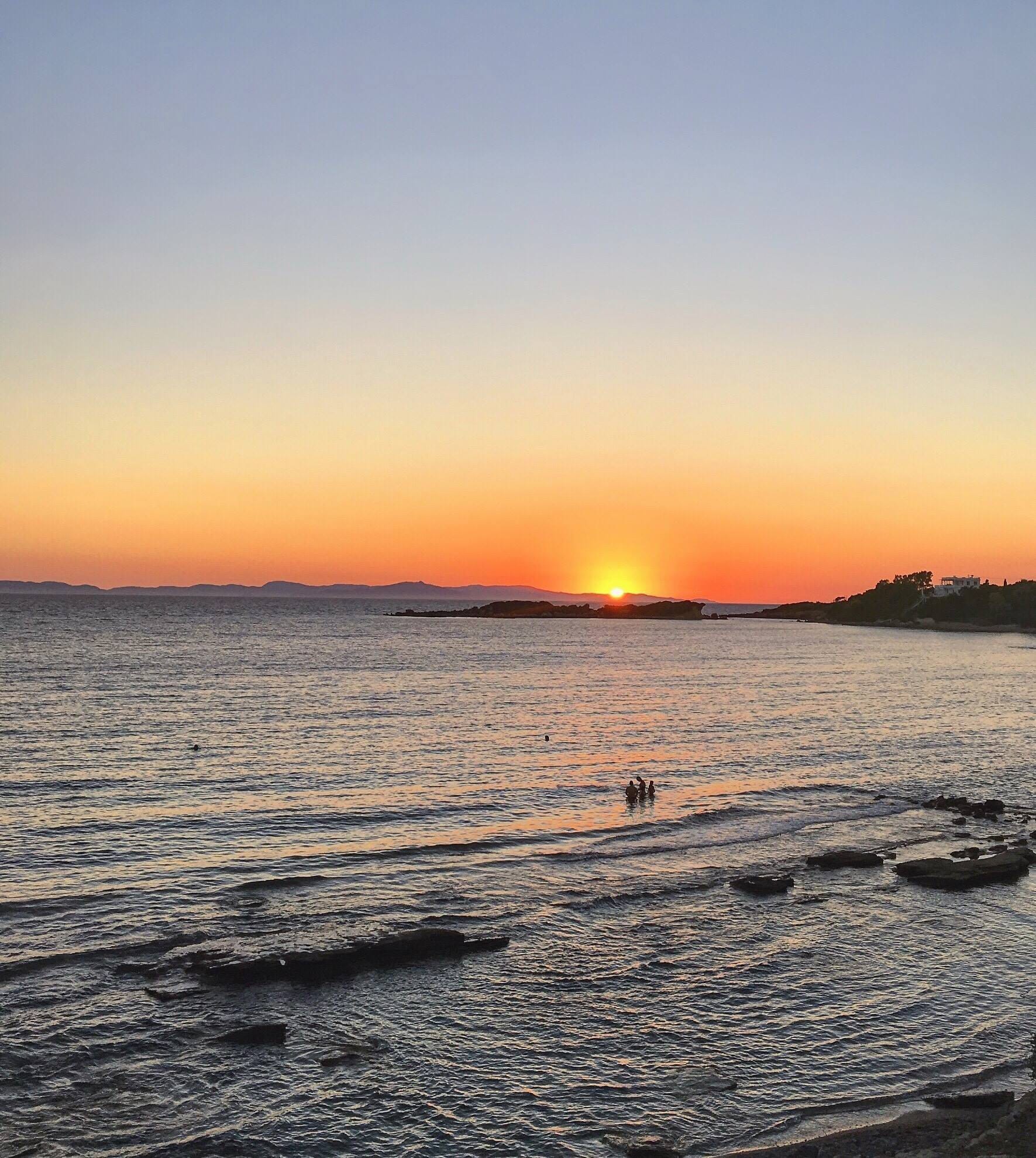 a sunset over a body of water