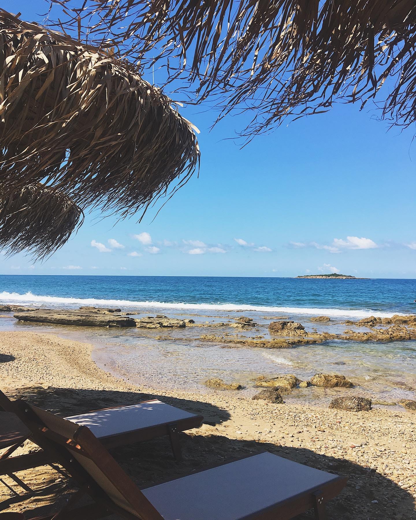 a beach with chairs and umbrellas