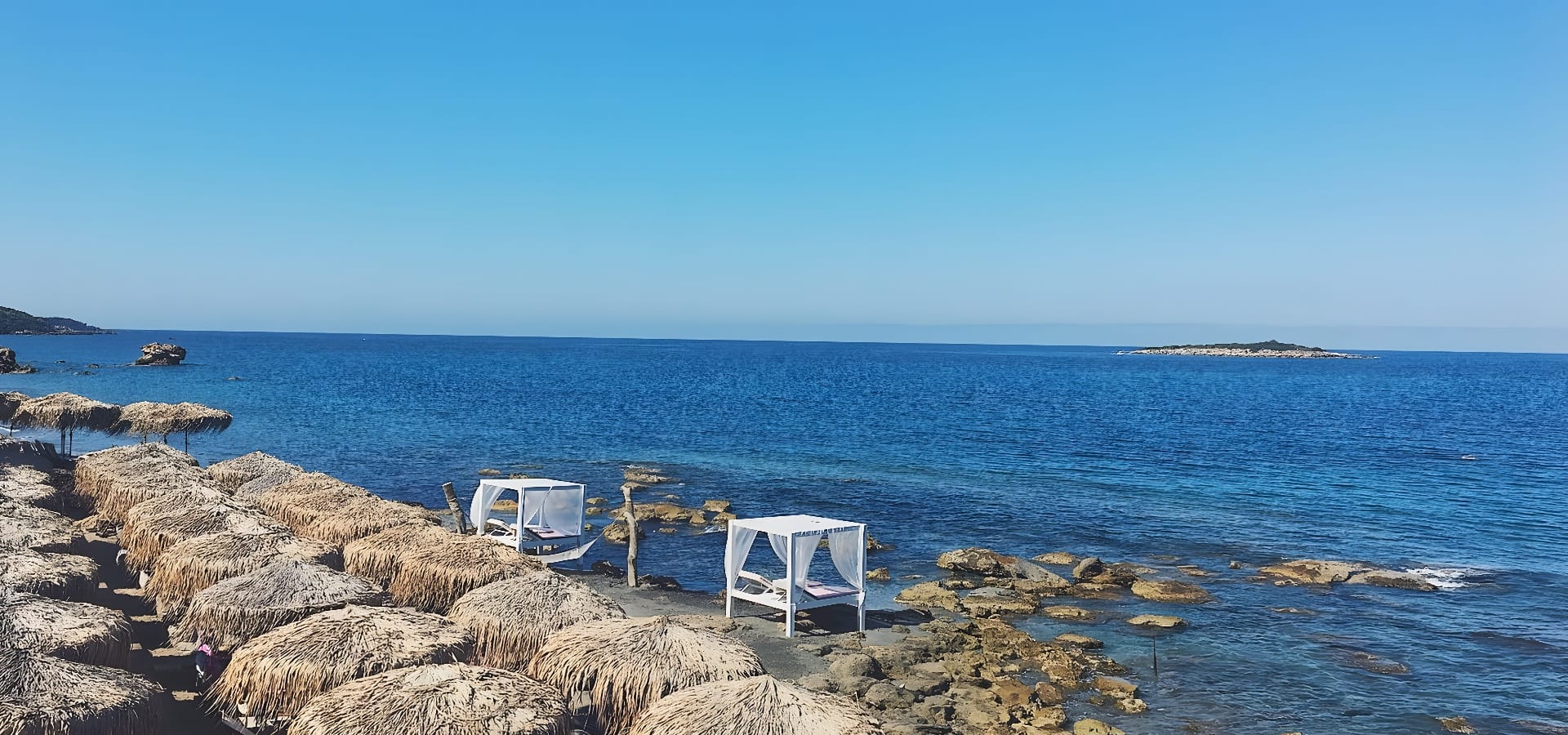 a white beds on a rocky beach