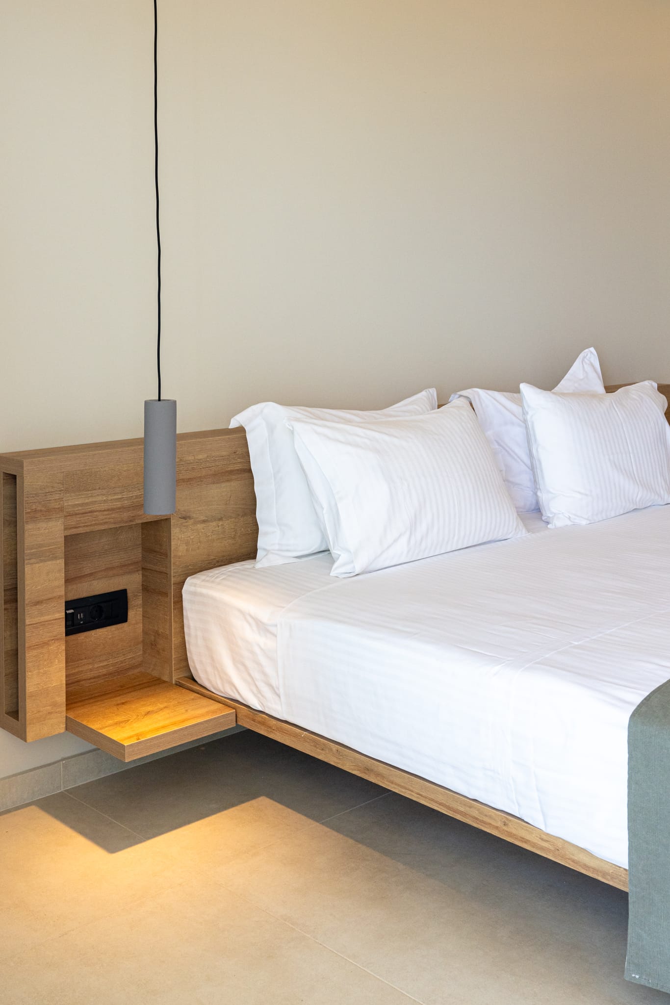 a bed with white sheets and a lamp