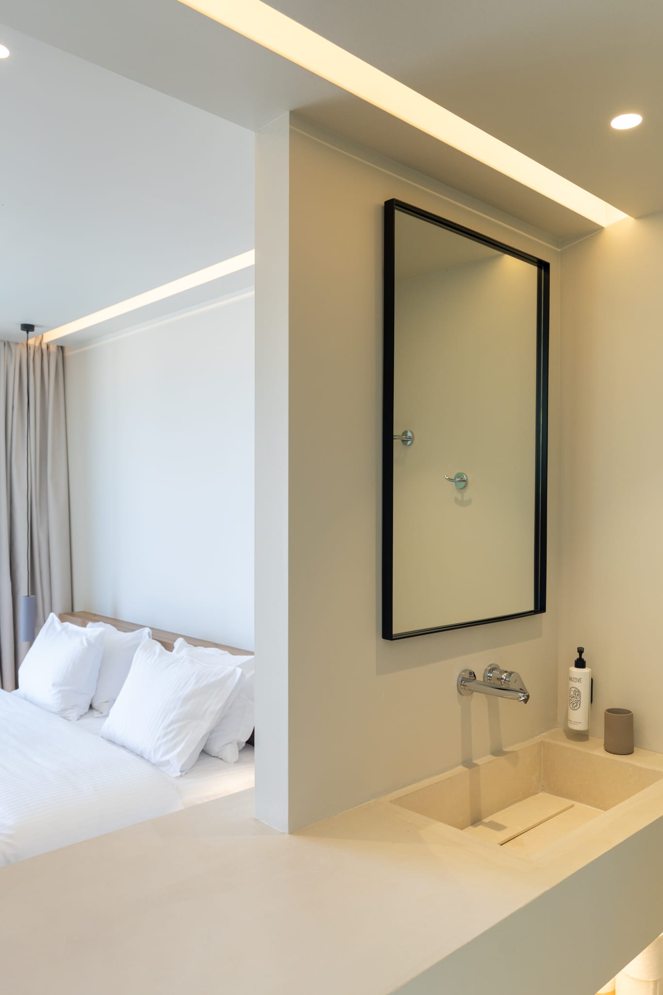 a bathroom with a mirror and a bed
