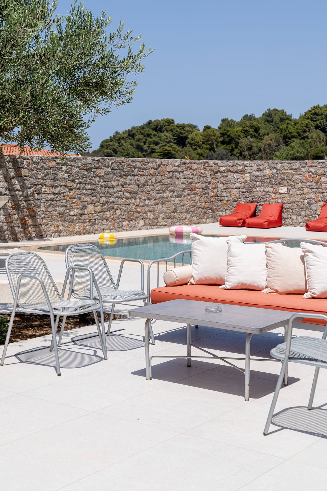 a pool with a couch and chairs