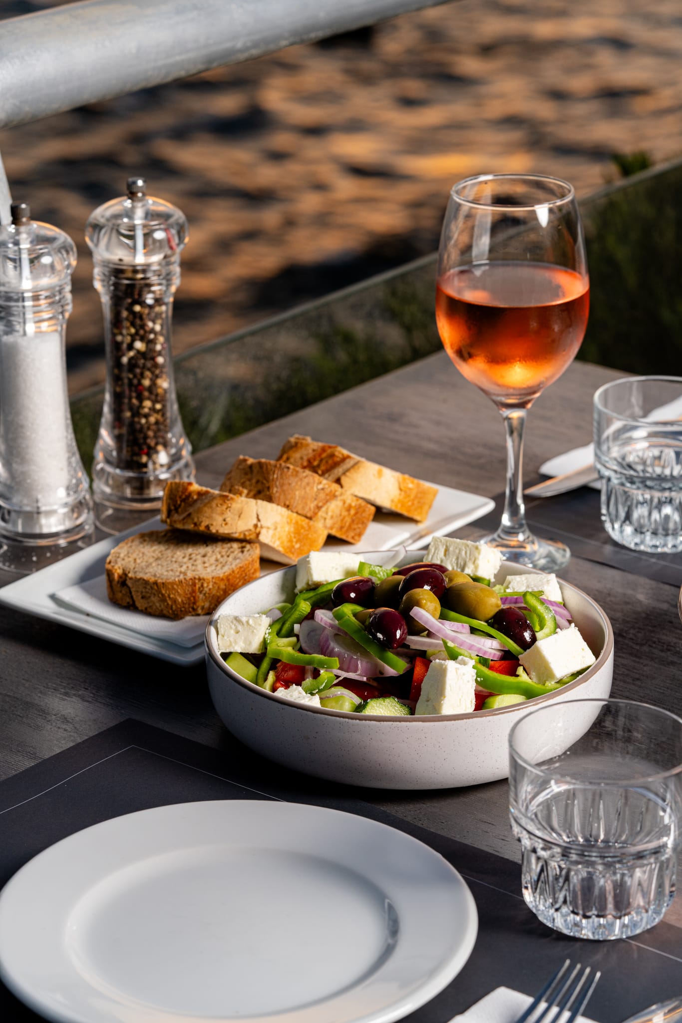 a bowl of salad and a glass of wine