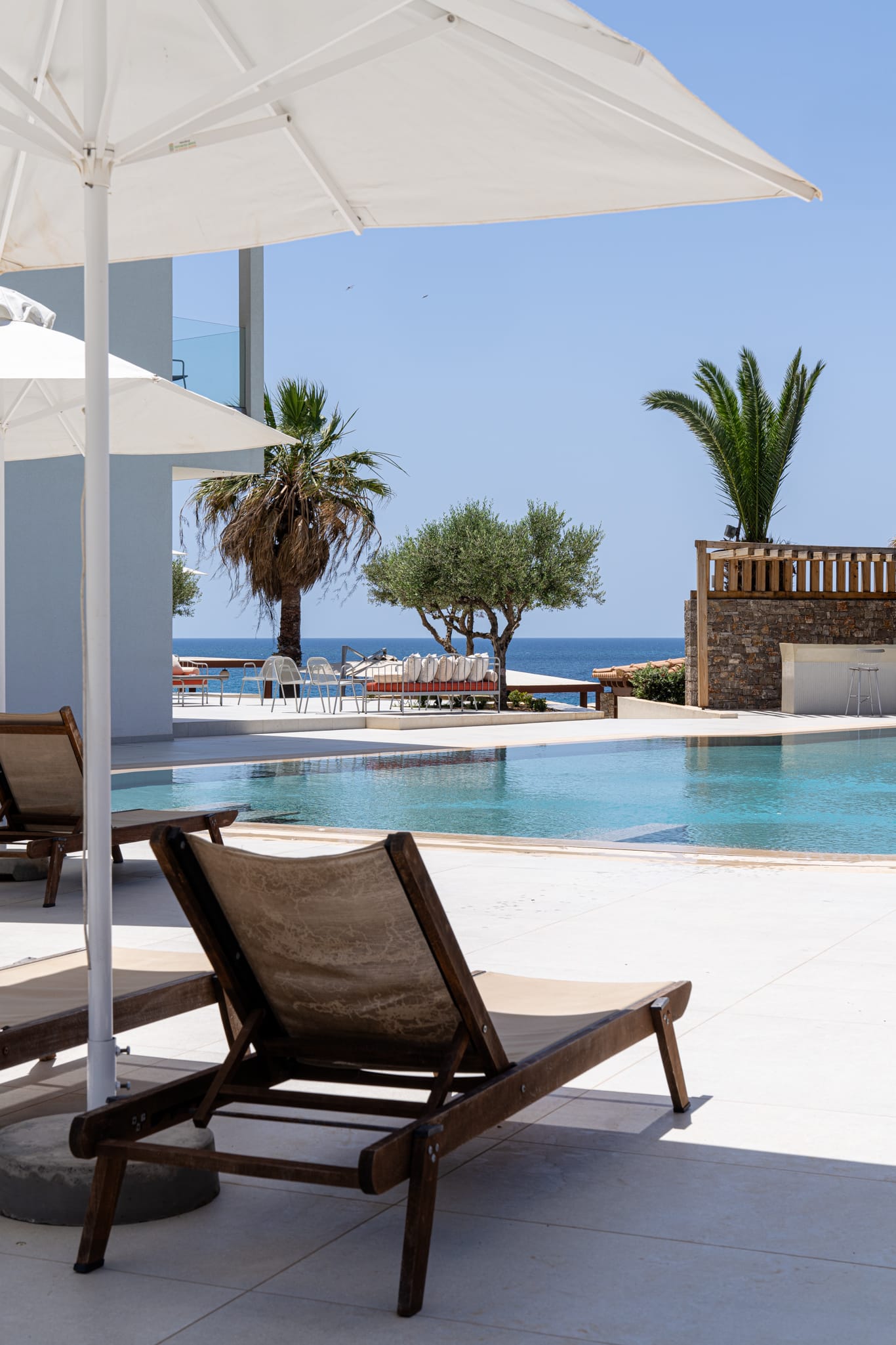 a pool with lounge chairs and umbrellas