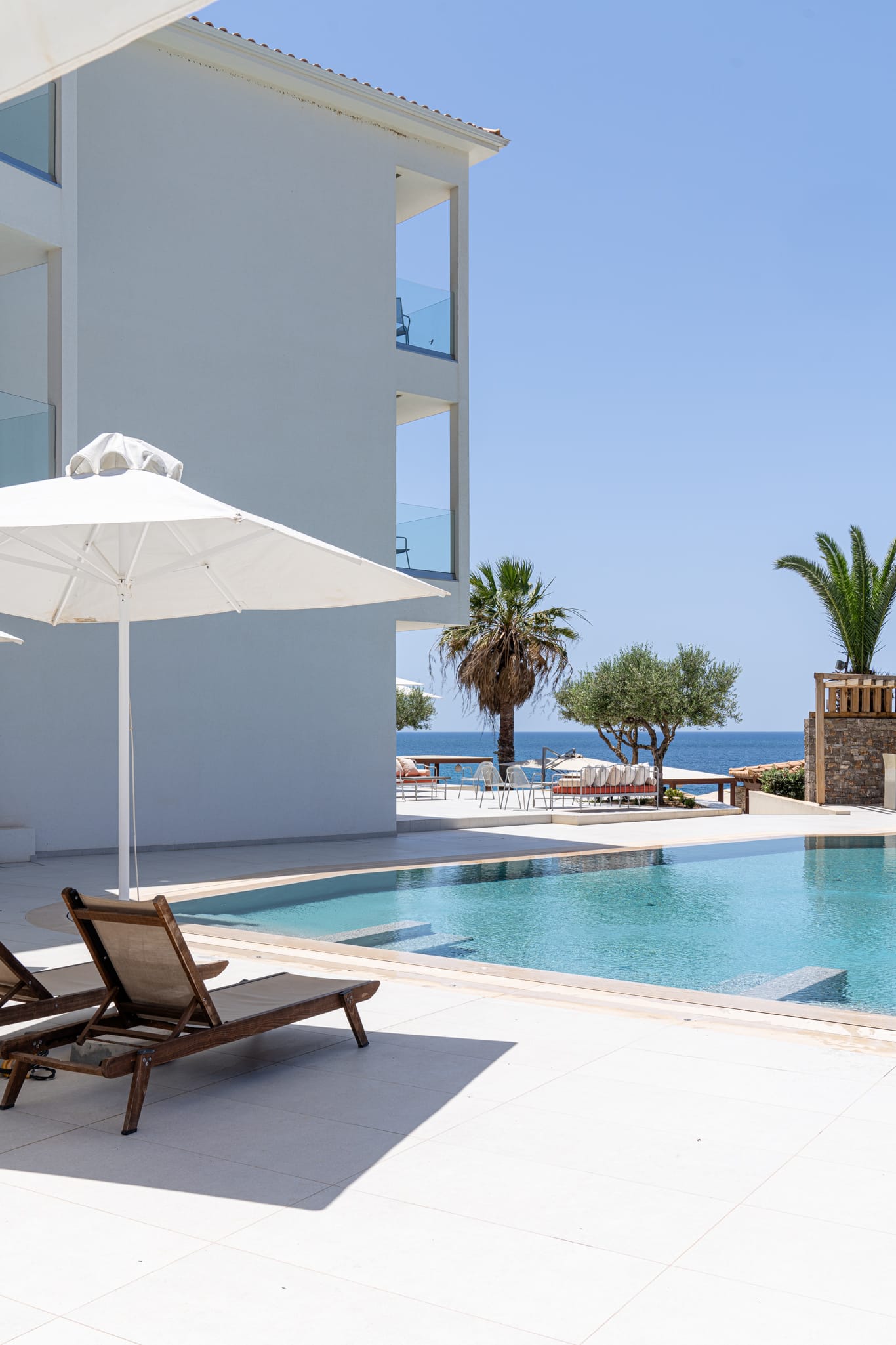 a pool with a lounge chair and umbrella