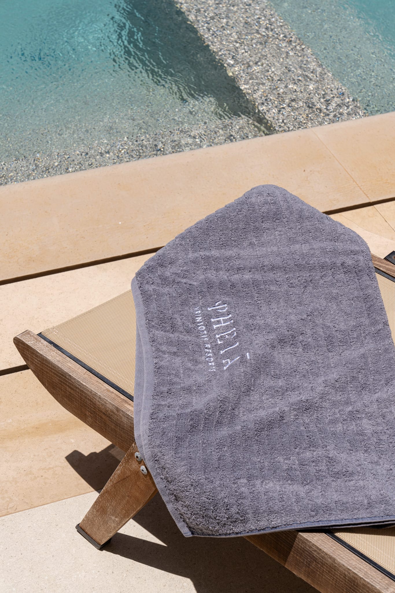 a towel on a chair by a pool