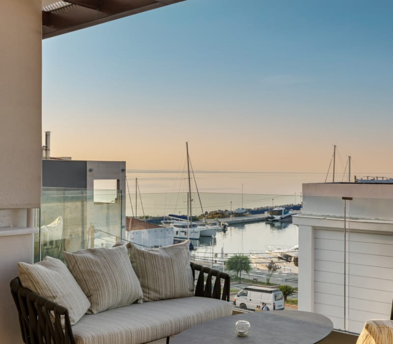 a room with a view of the ocean and a deck