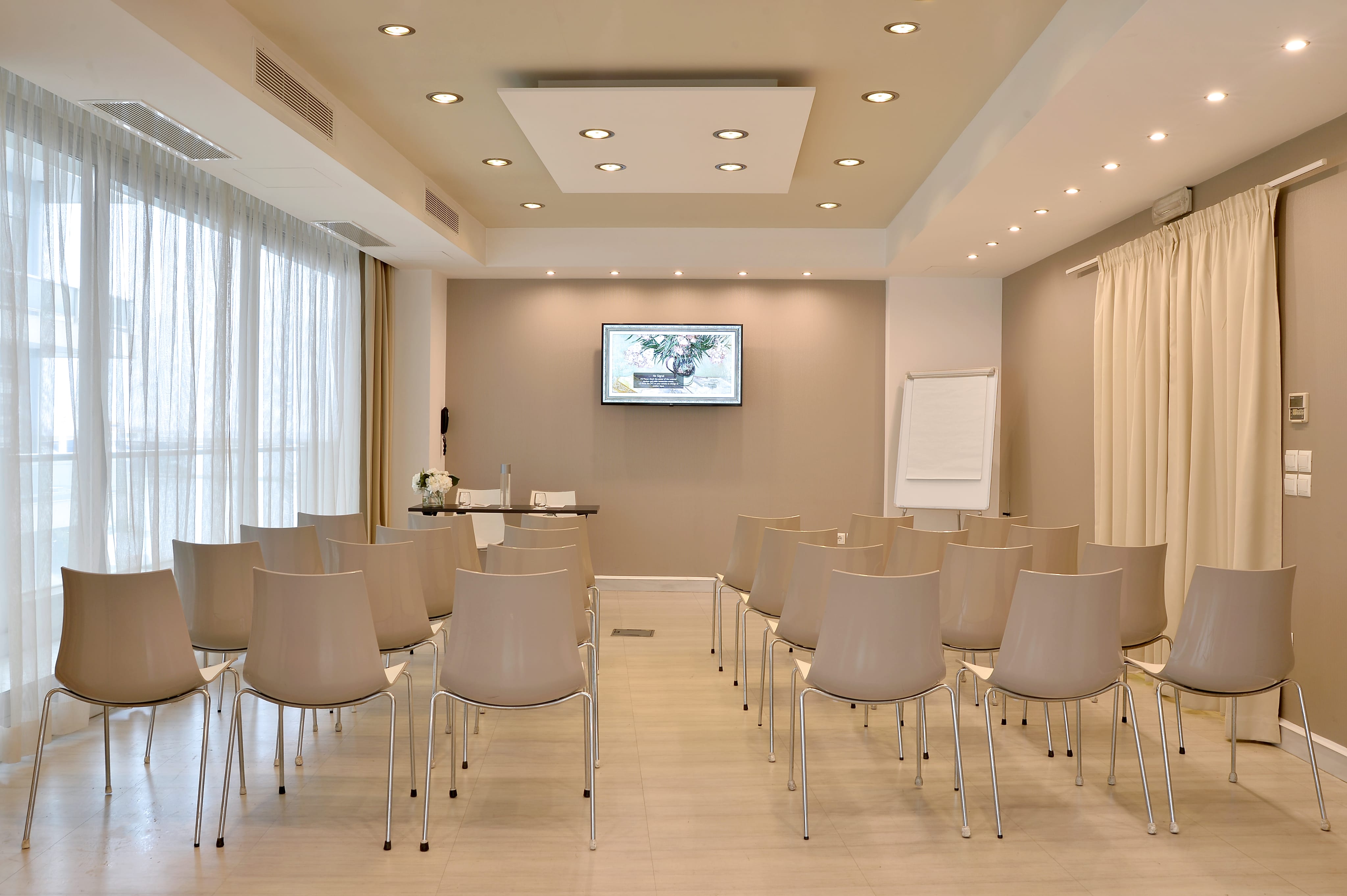 a room with chairs and a screen
