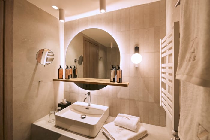 a bathroom with a round mirror