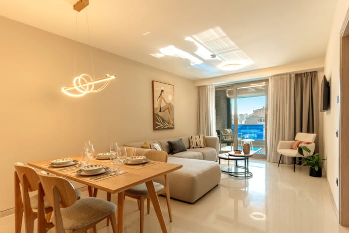a living room with a table and chairs