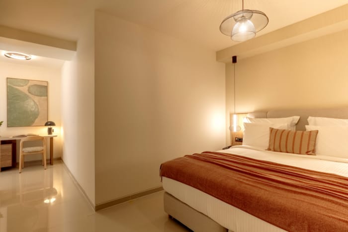 a bedroom with a bed and a lamp