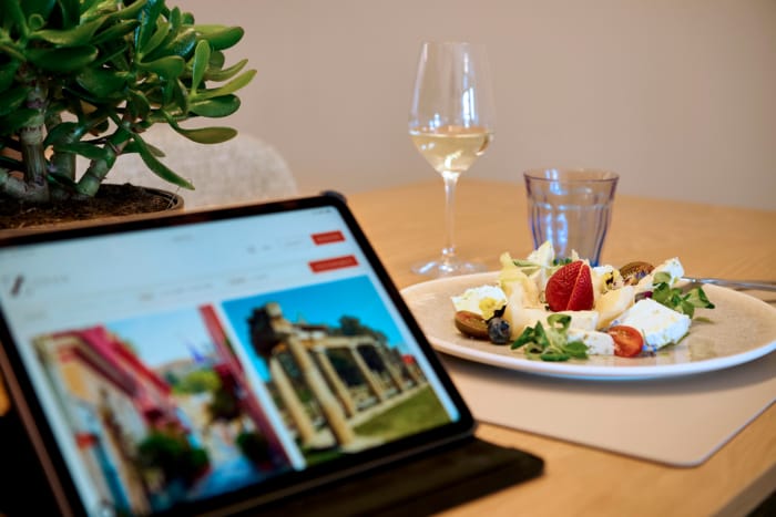 a tablet and a plate of food